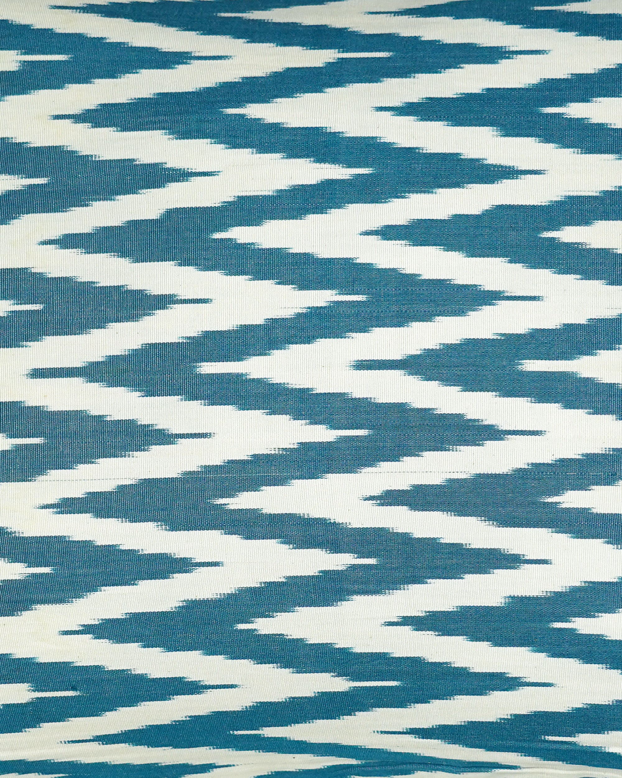 Close up detail of the Ikat patterned cushion with blue and white zigzag design