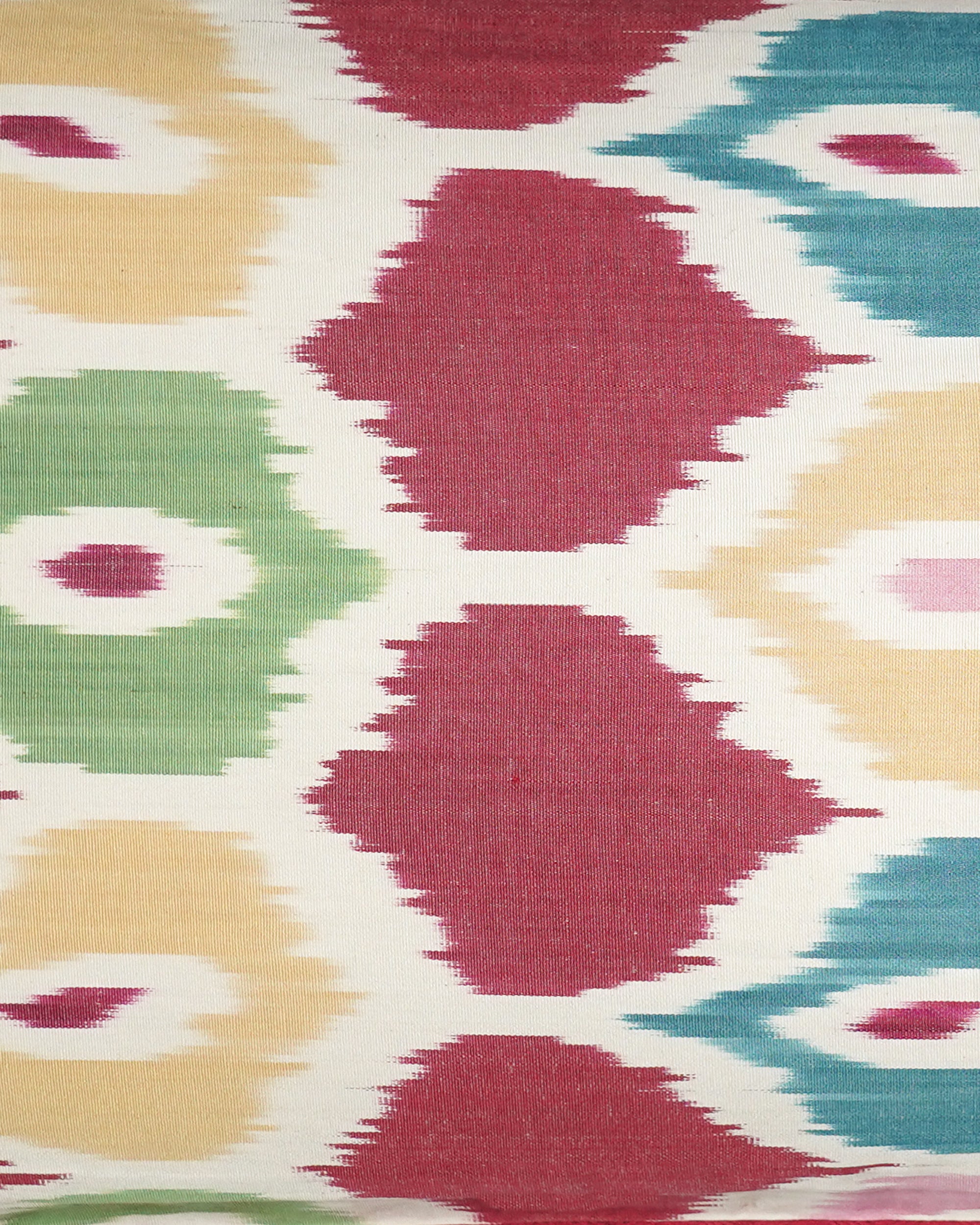 Colorful patterned Ikat fabric with geometric shapes on a white background