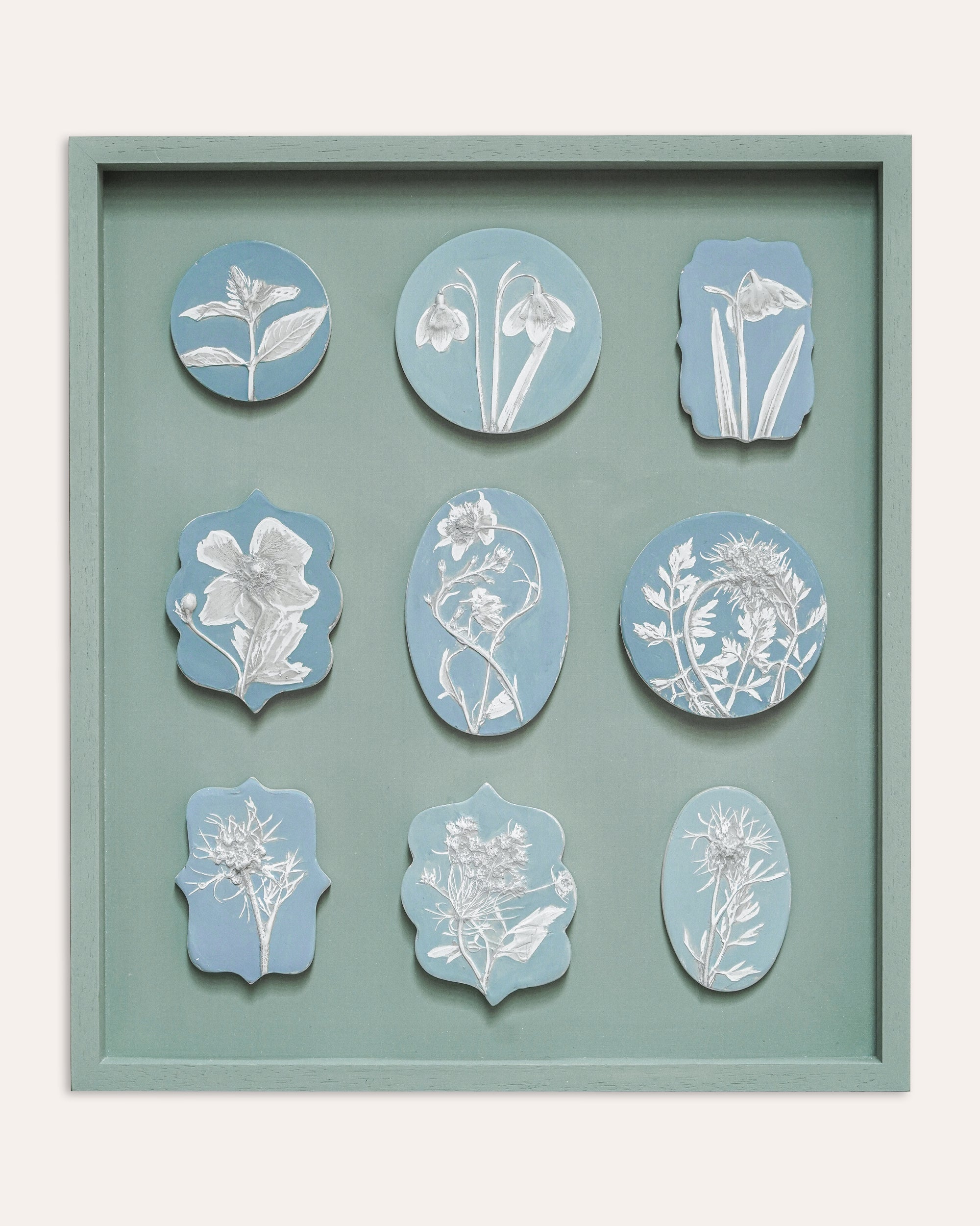 Decorative wall art with floral designs on a light blue background