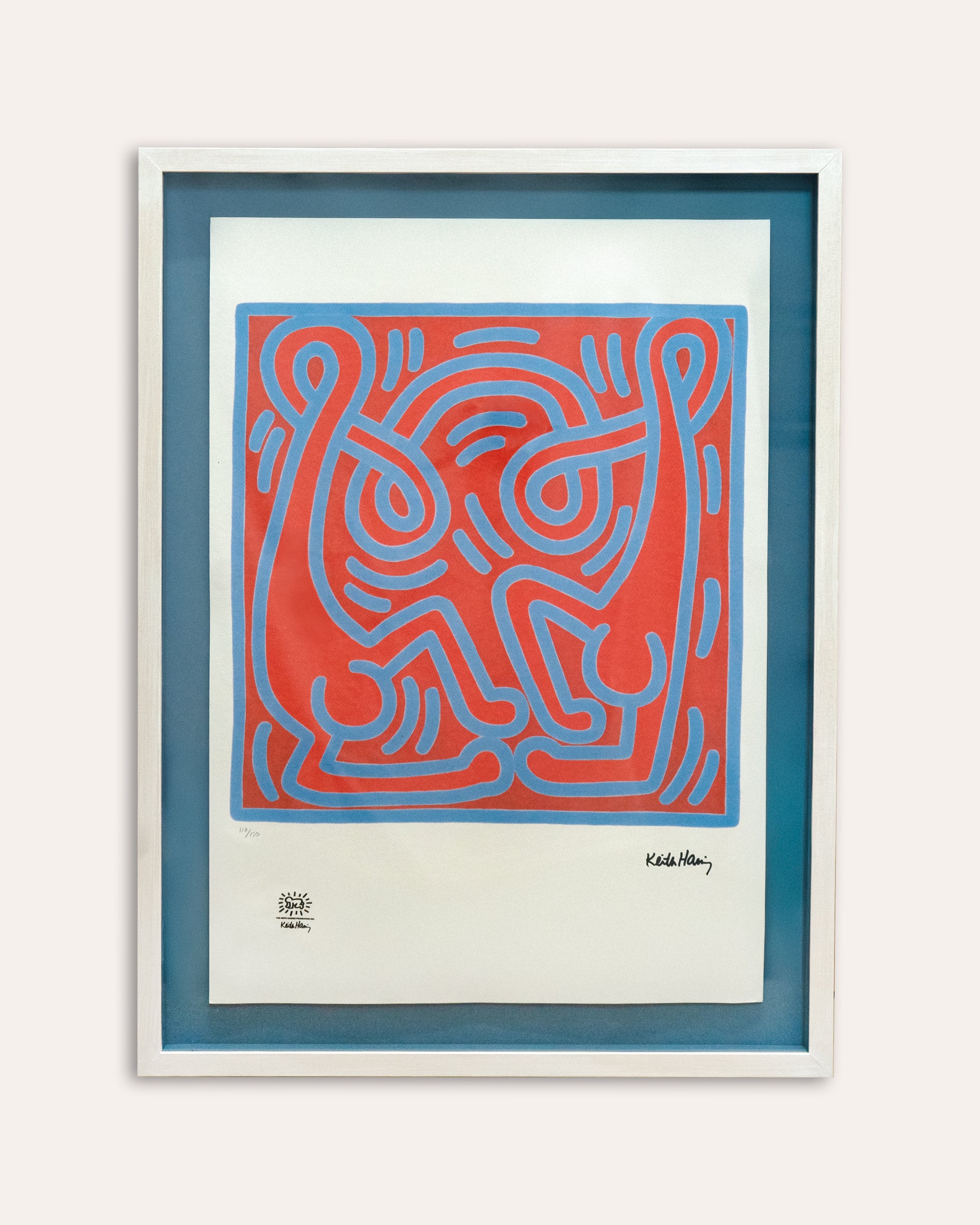 Framed abstract artwork with blue and red design on a white background