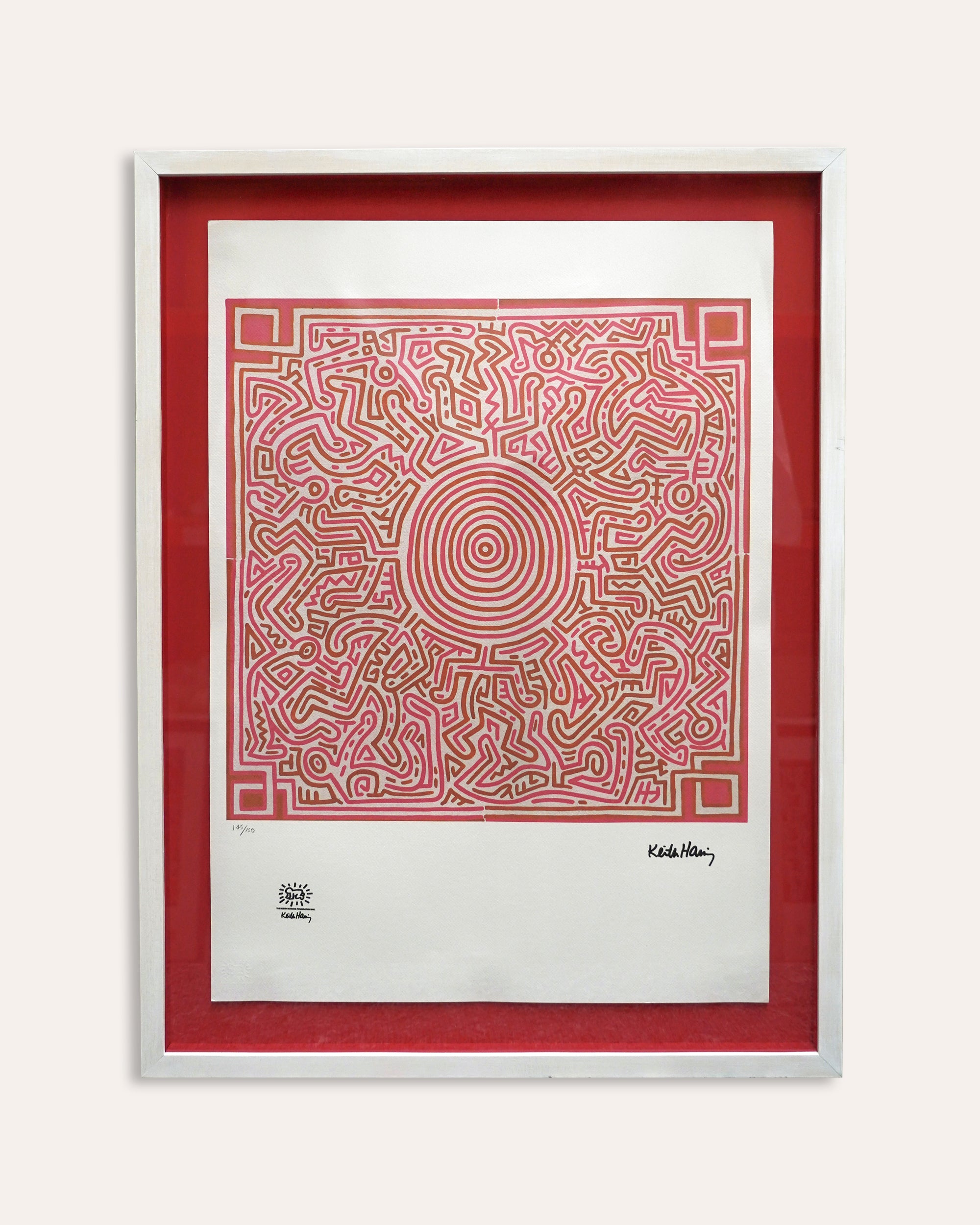Framed artwork with a red and beige maze design on a white background