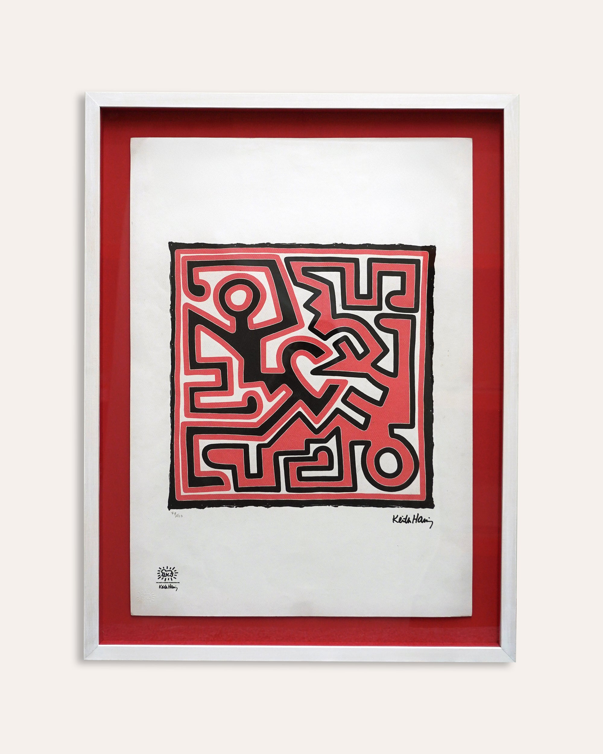 Framed artwork with a red border featuring a geometric design on a white background