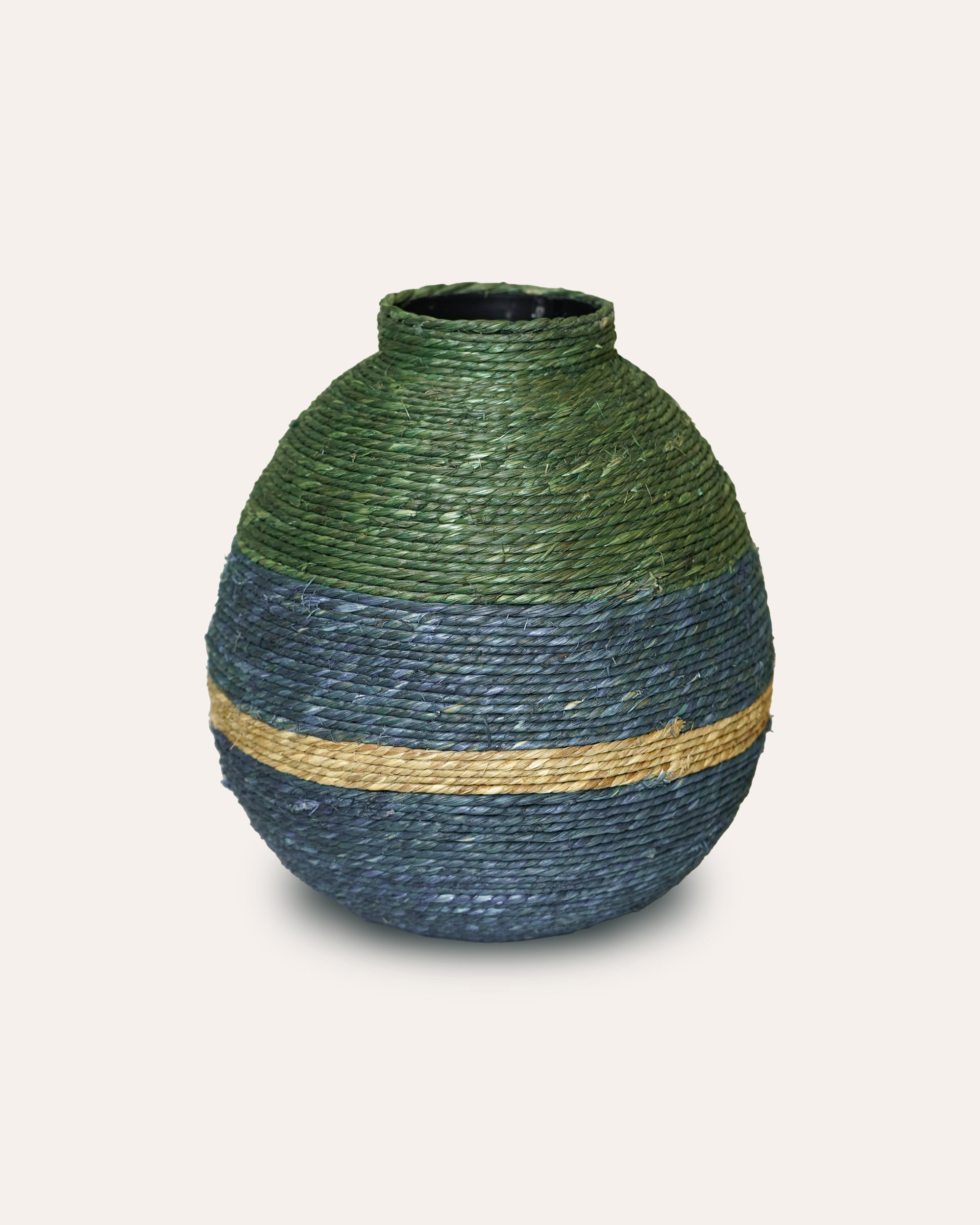 Decorative vase with green and blue striped design on a light white background