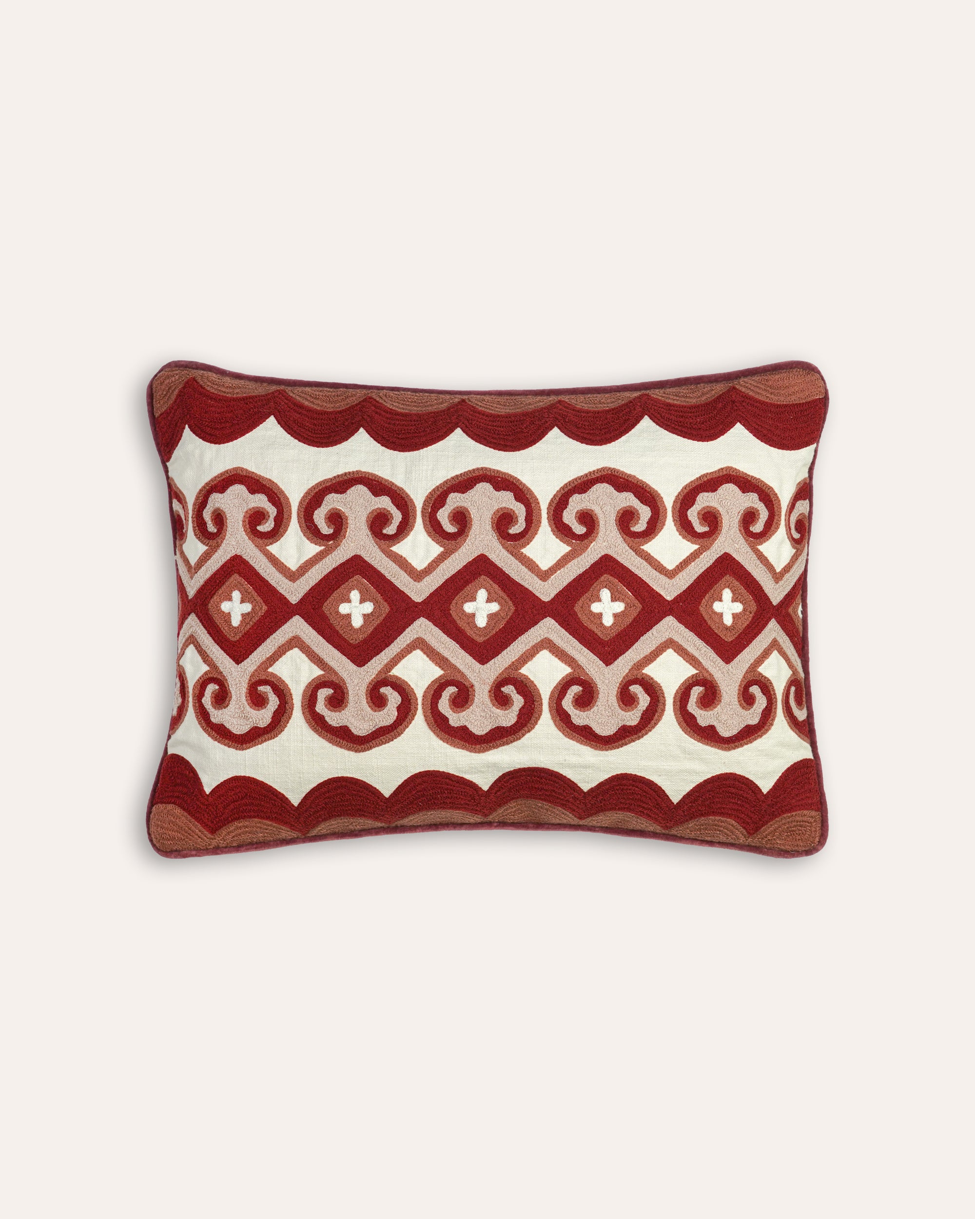 Decorative cushion with red and white pattern on a white background