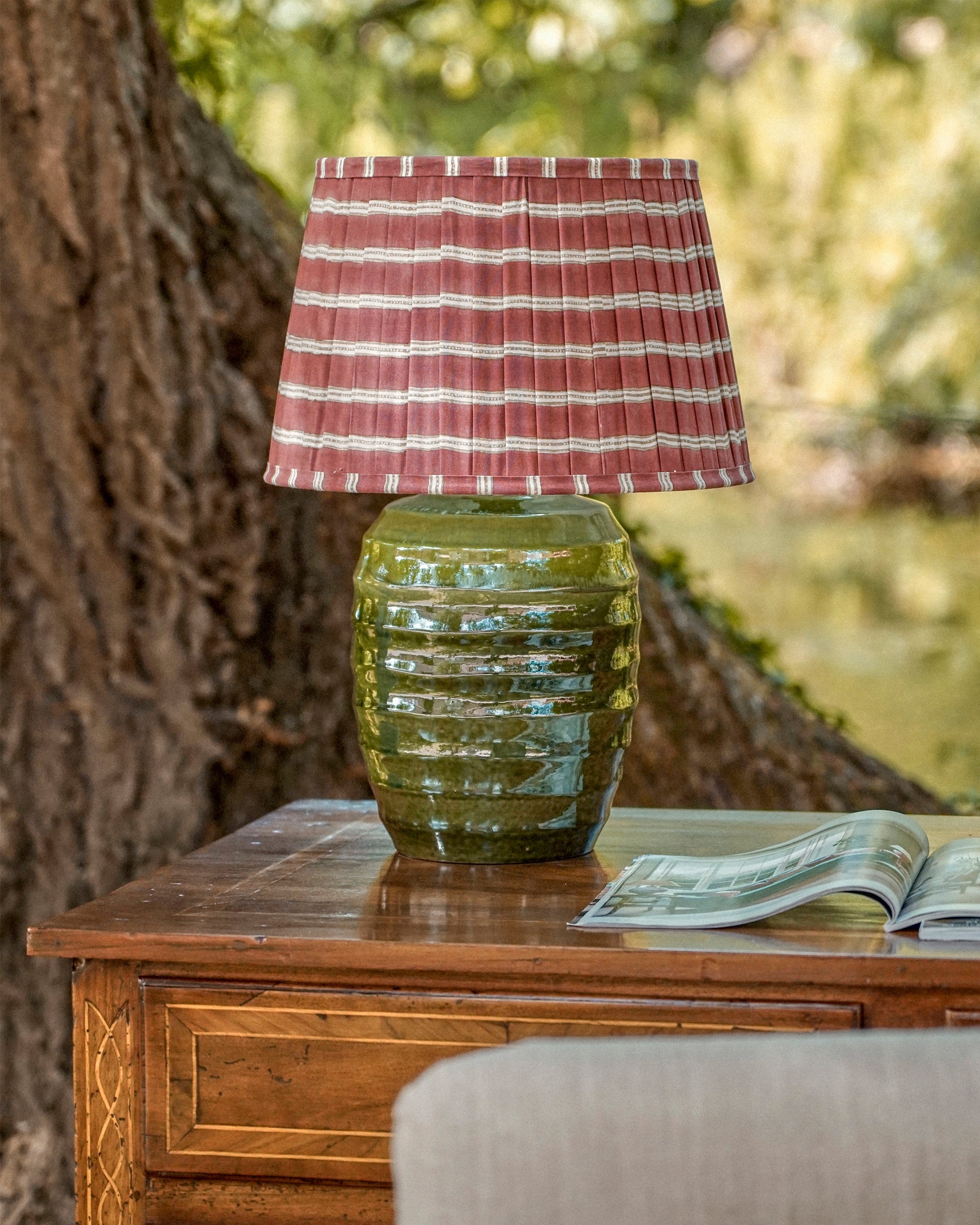 Edo pleated lampshade on a green beehive lamp base