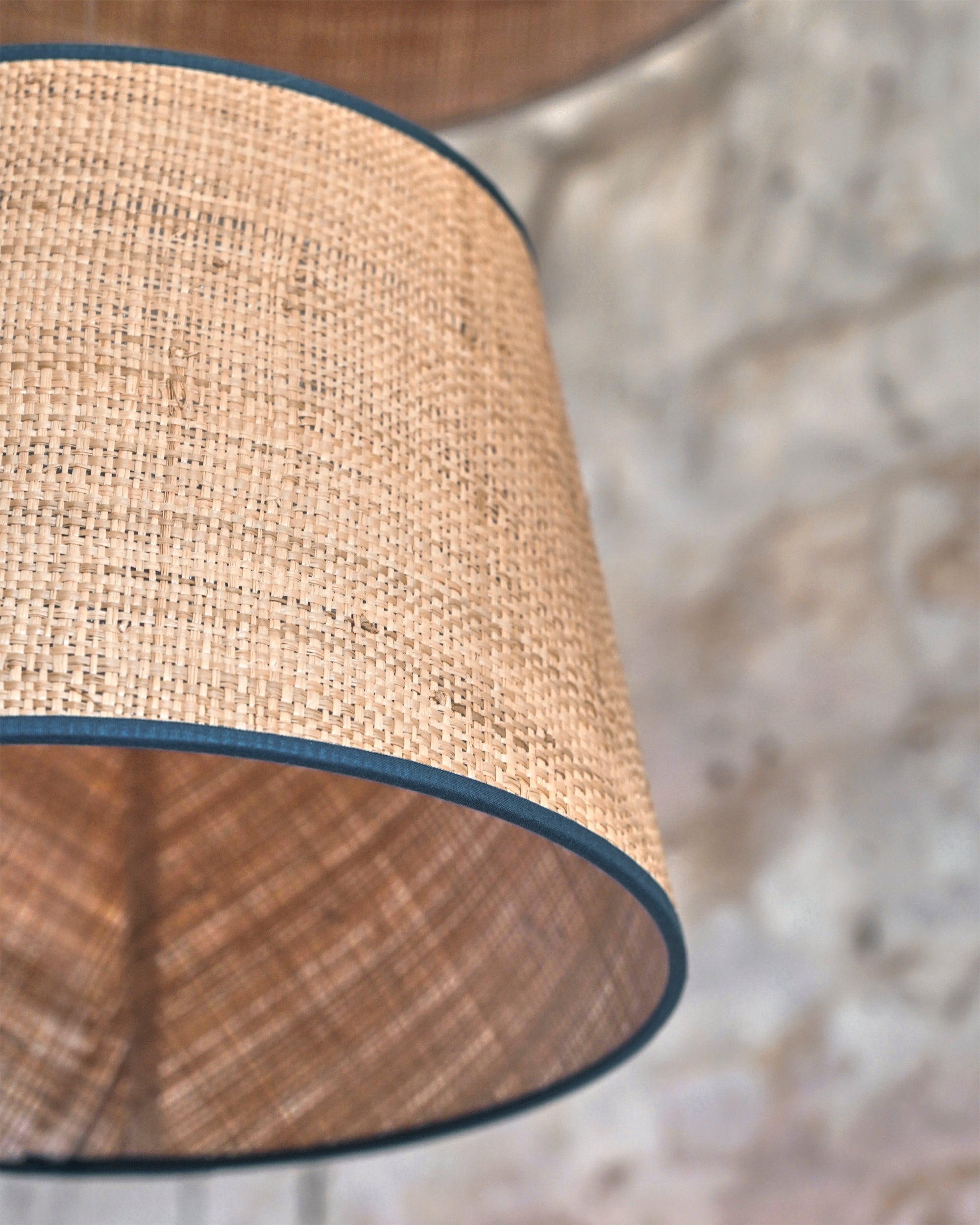 Close-up of a textured lampshade with a blurred background