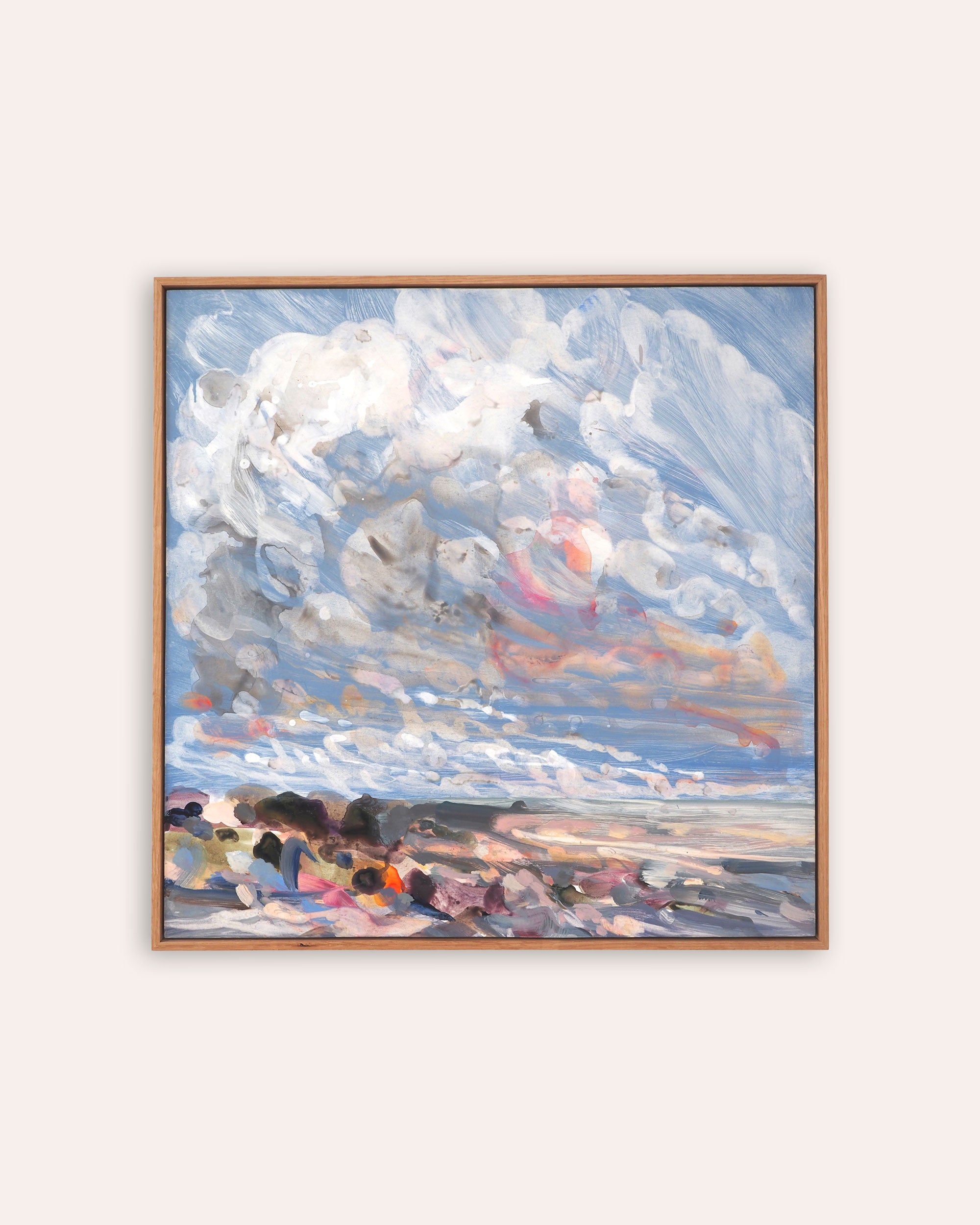 A framed square painting depicting an abstract seascape with dramatic white and blue clouds, soft pink and orange light, and a dark shoreline, shown against a light beige background.