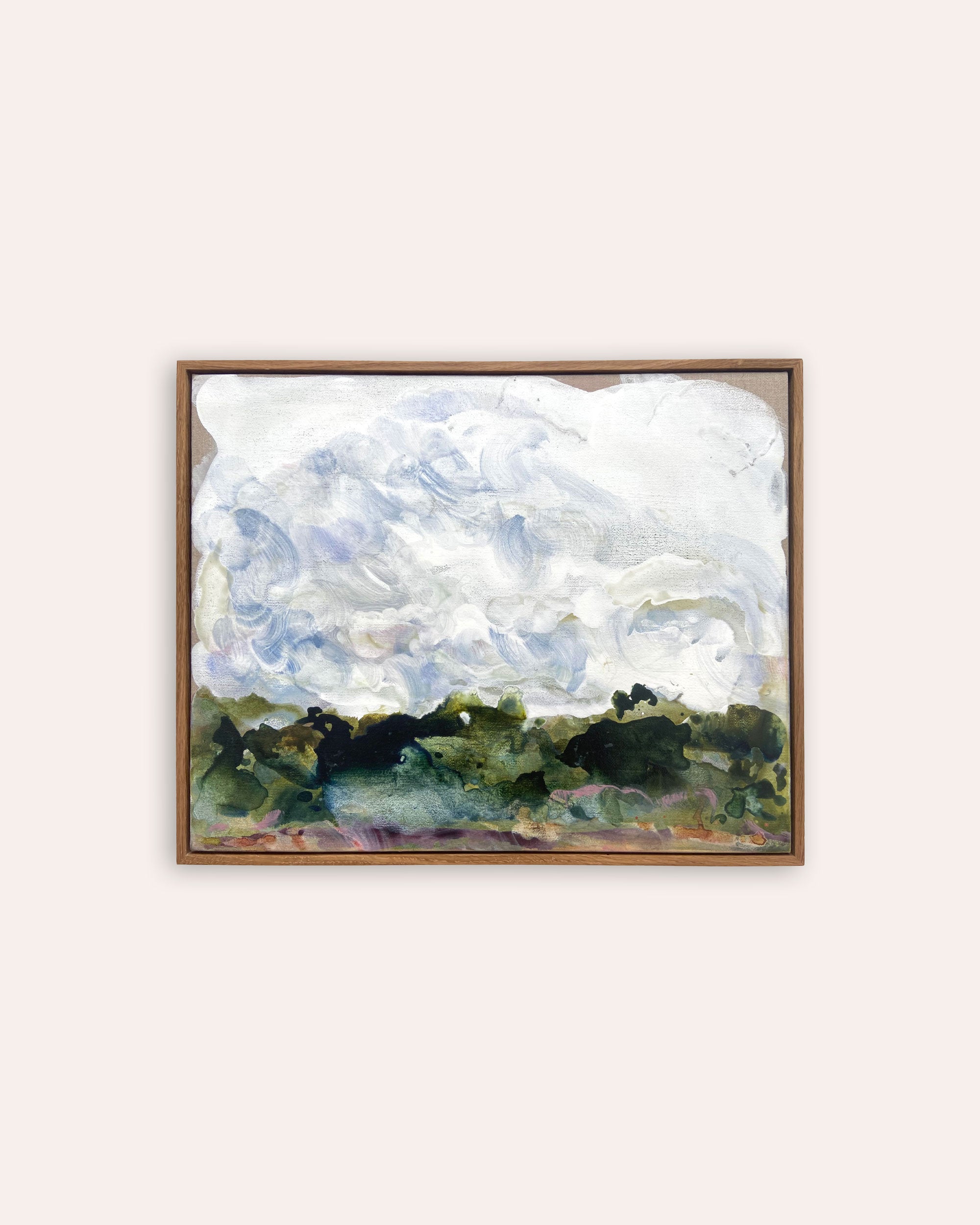 A framed landscape painting featuring textured white and blue clouds above a dark green and olive tree line, displayed on a light beige background.