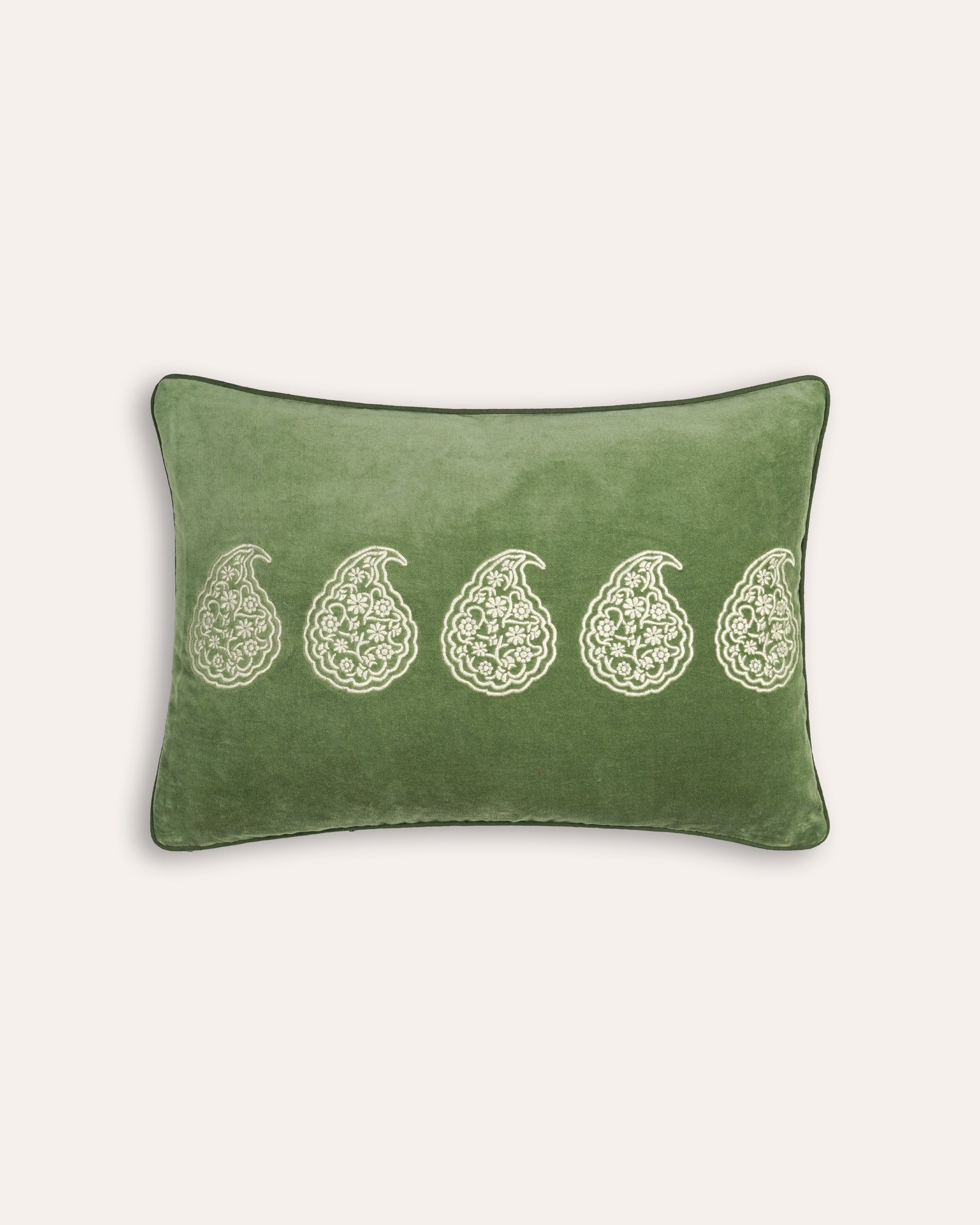 Green rectangular cushion with white paisley patterns on a white background