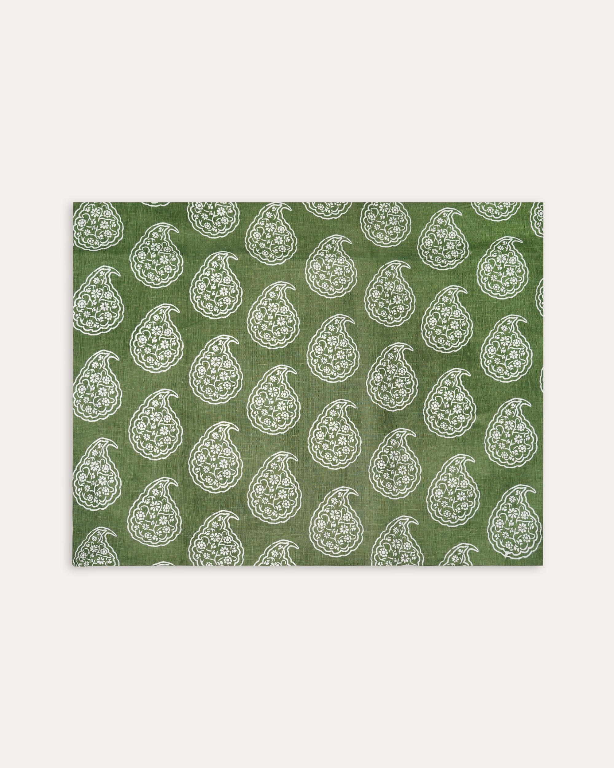 Green tablecloth with white floral pattern on a white background