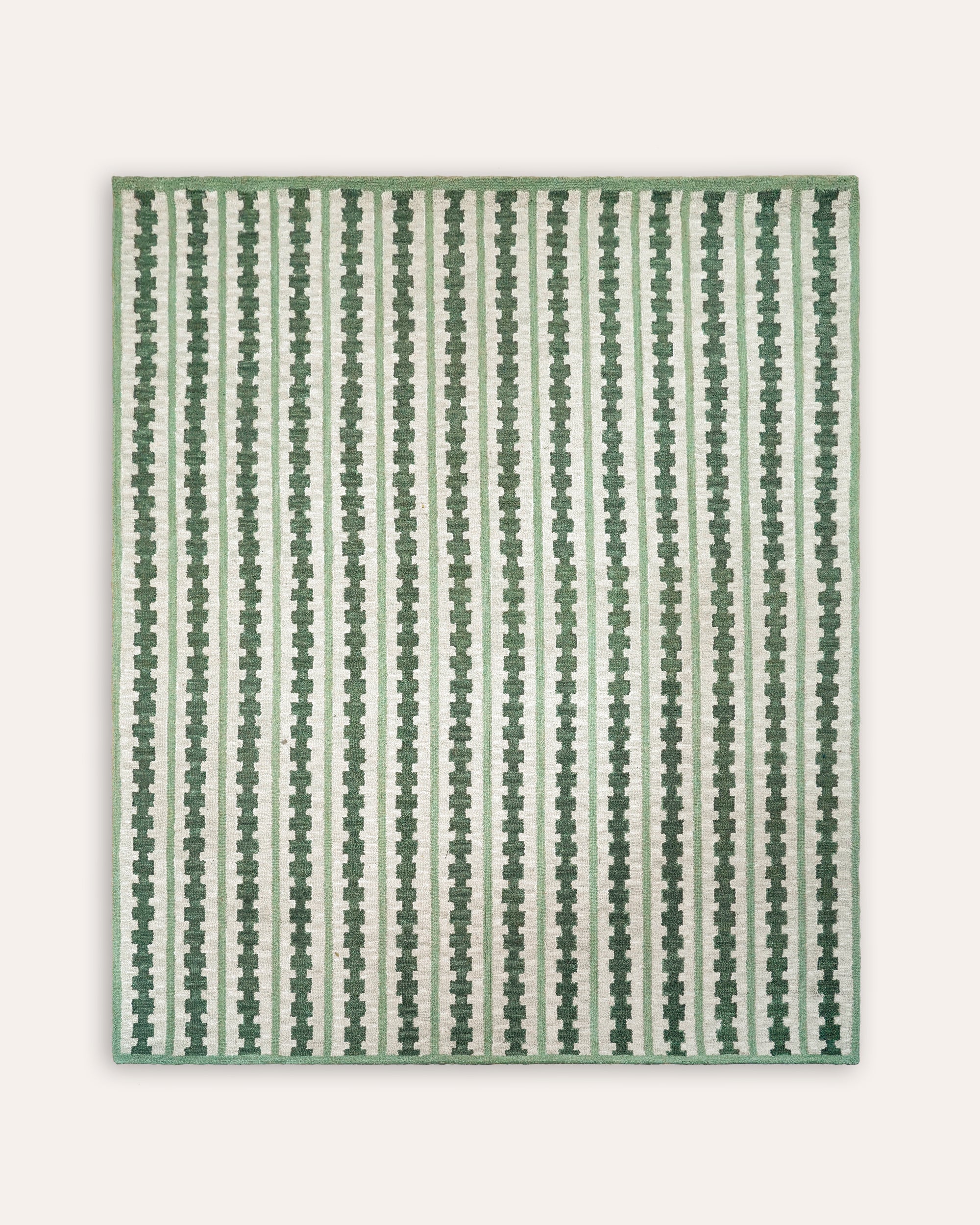 Green and white striped patterned rug on a white background