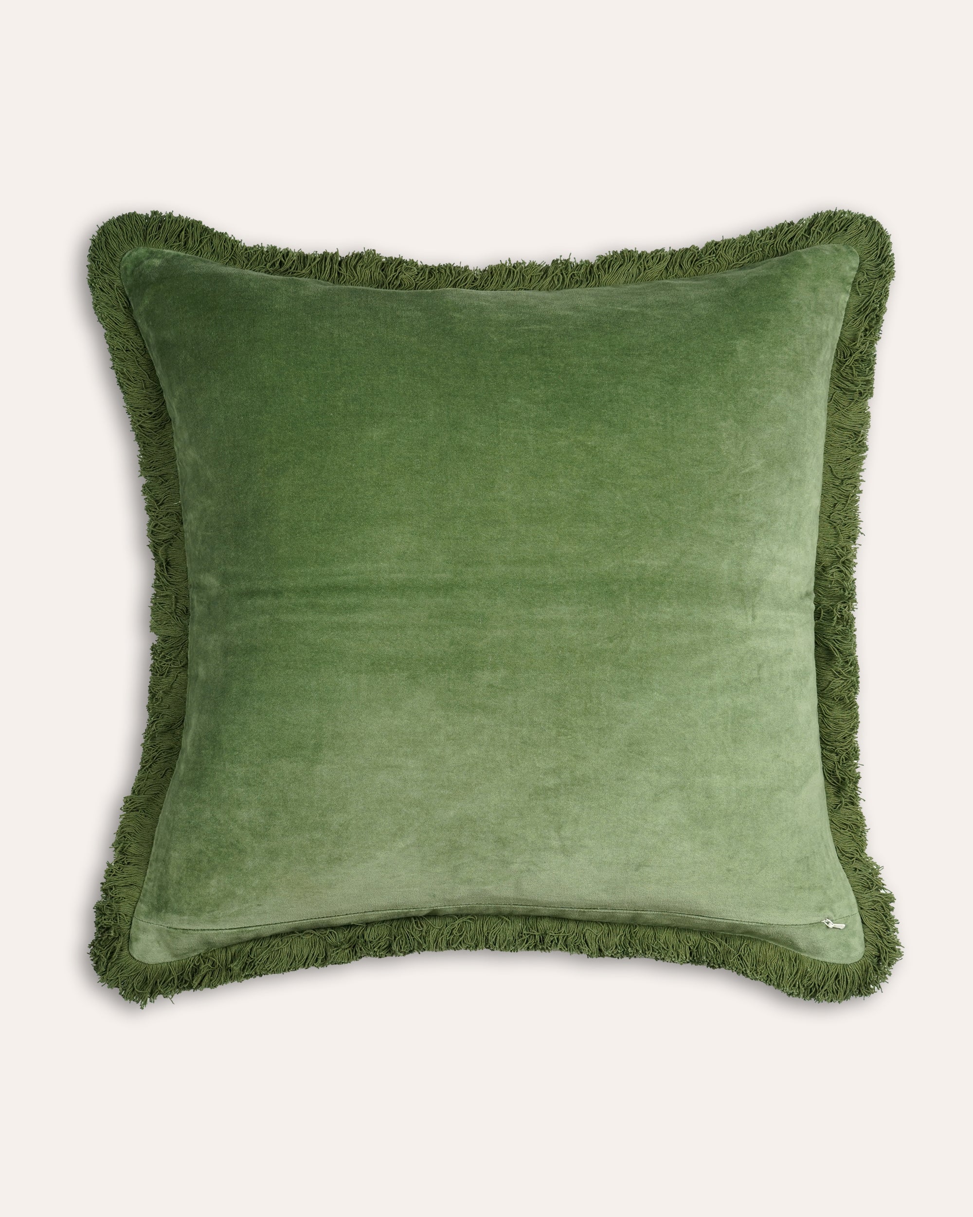 Green cushion with frayed edges on a white background