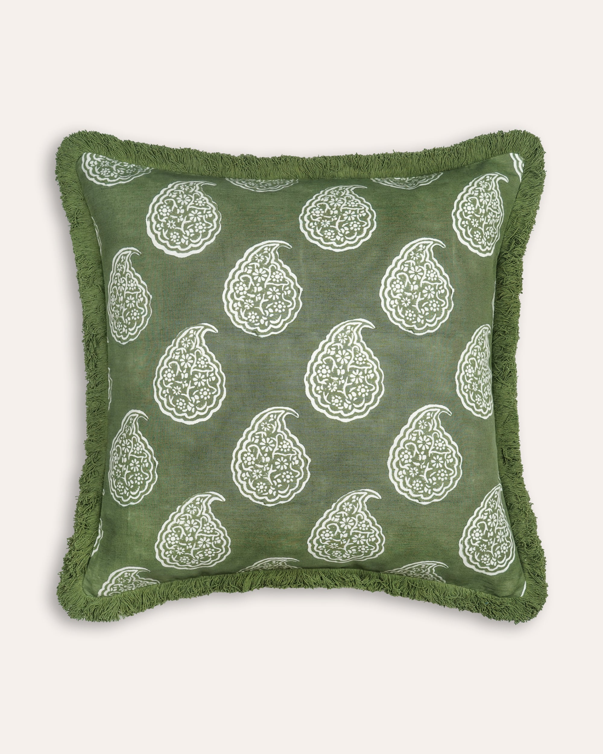 Green cushion with white paisley pattern on a white background