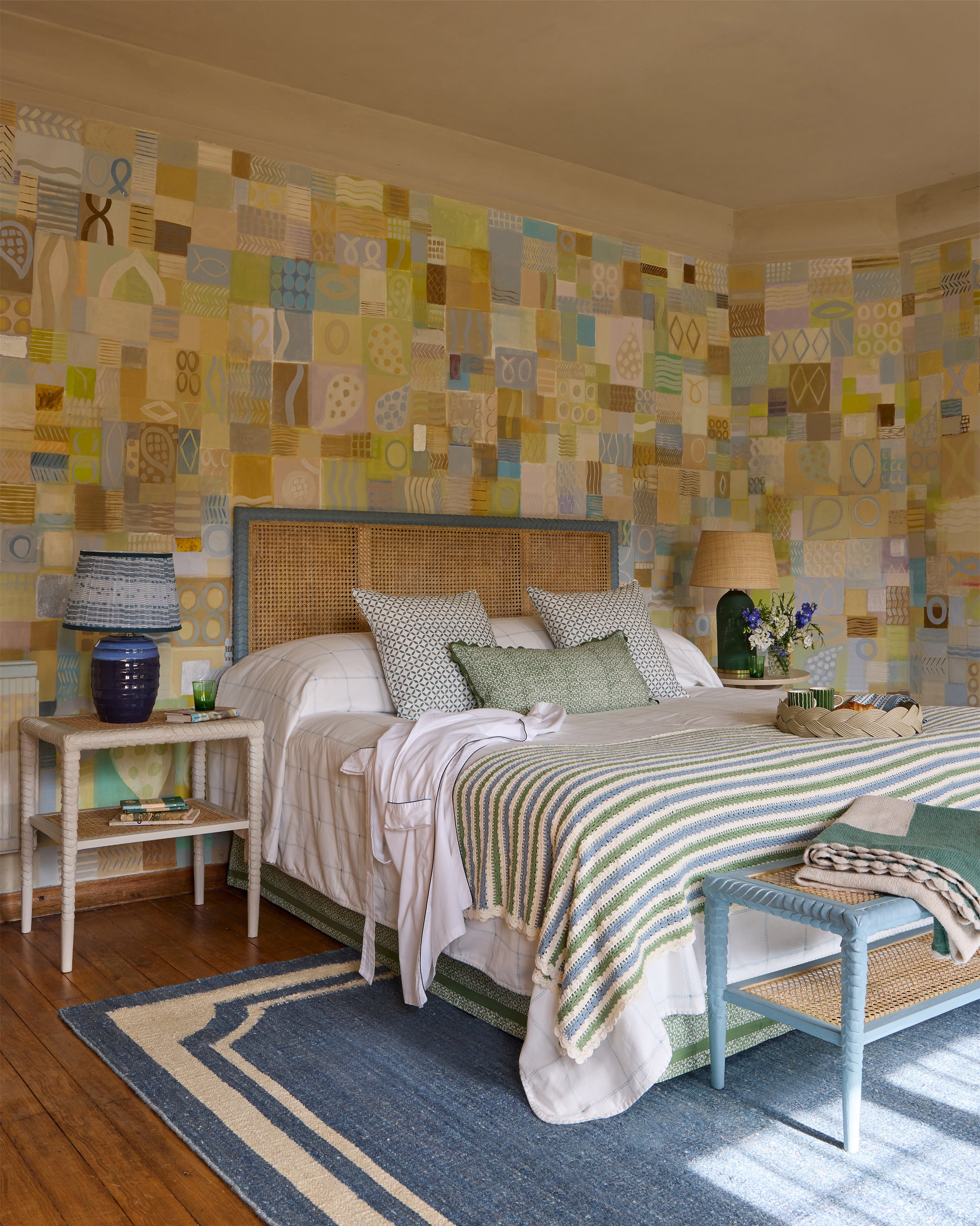 Blue and green bedroom lifestyle image, featuring geometric and stripe patterns