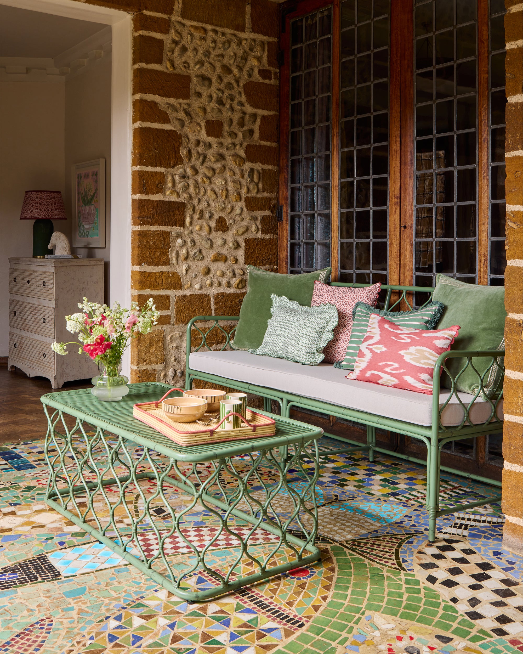 Spring summer Curato garden furniture lifestyle image featuring our pink Ciculo block print cushion