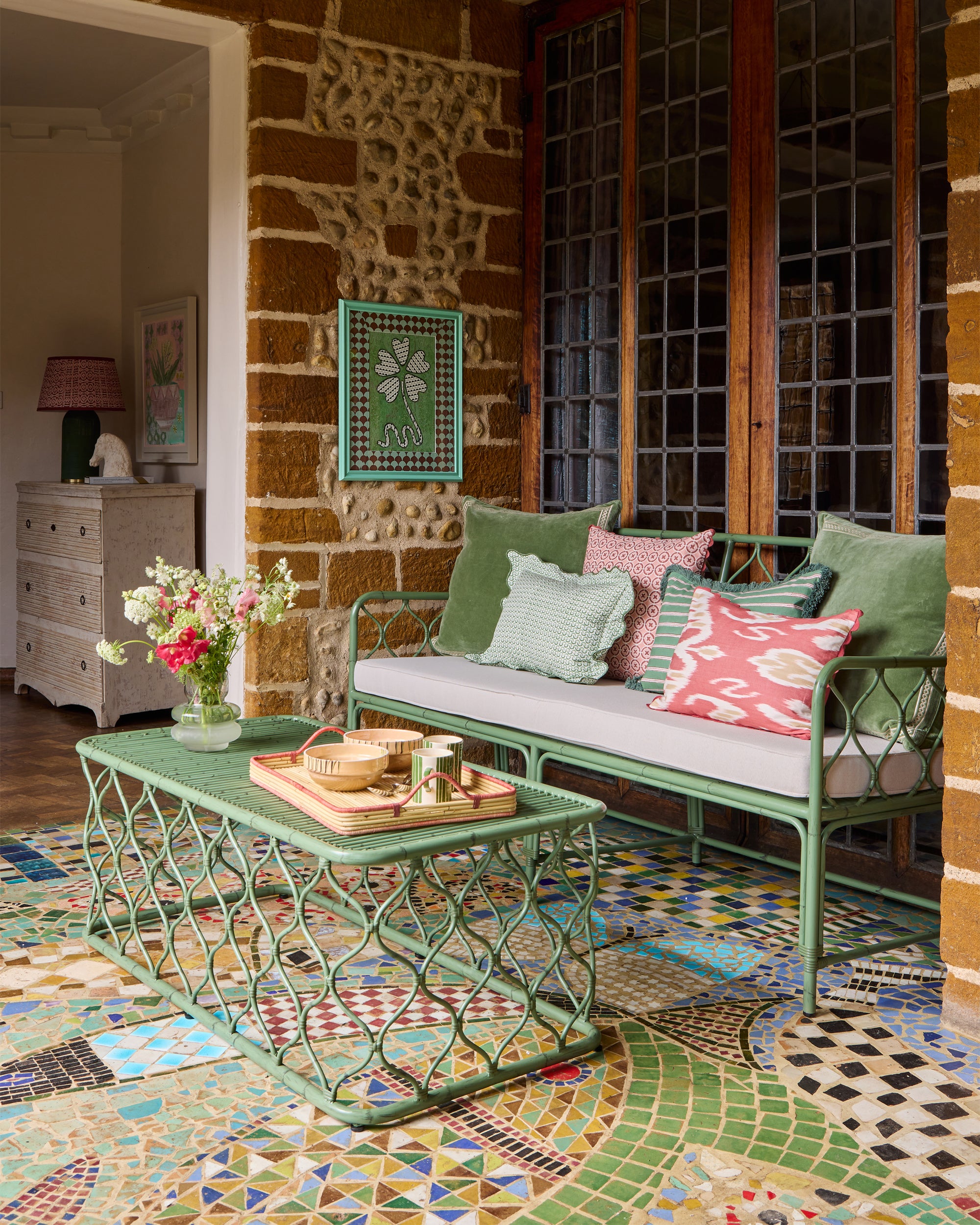 Pink and green sitting room, styled with the green curato garden furniture and a range of Birdie Fortescue's spring summer pink and green cushions