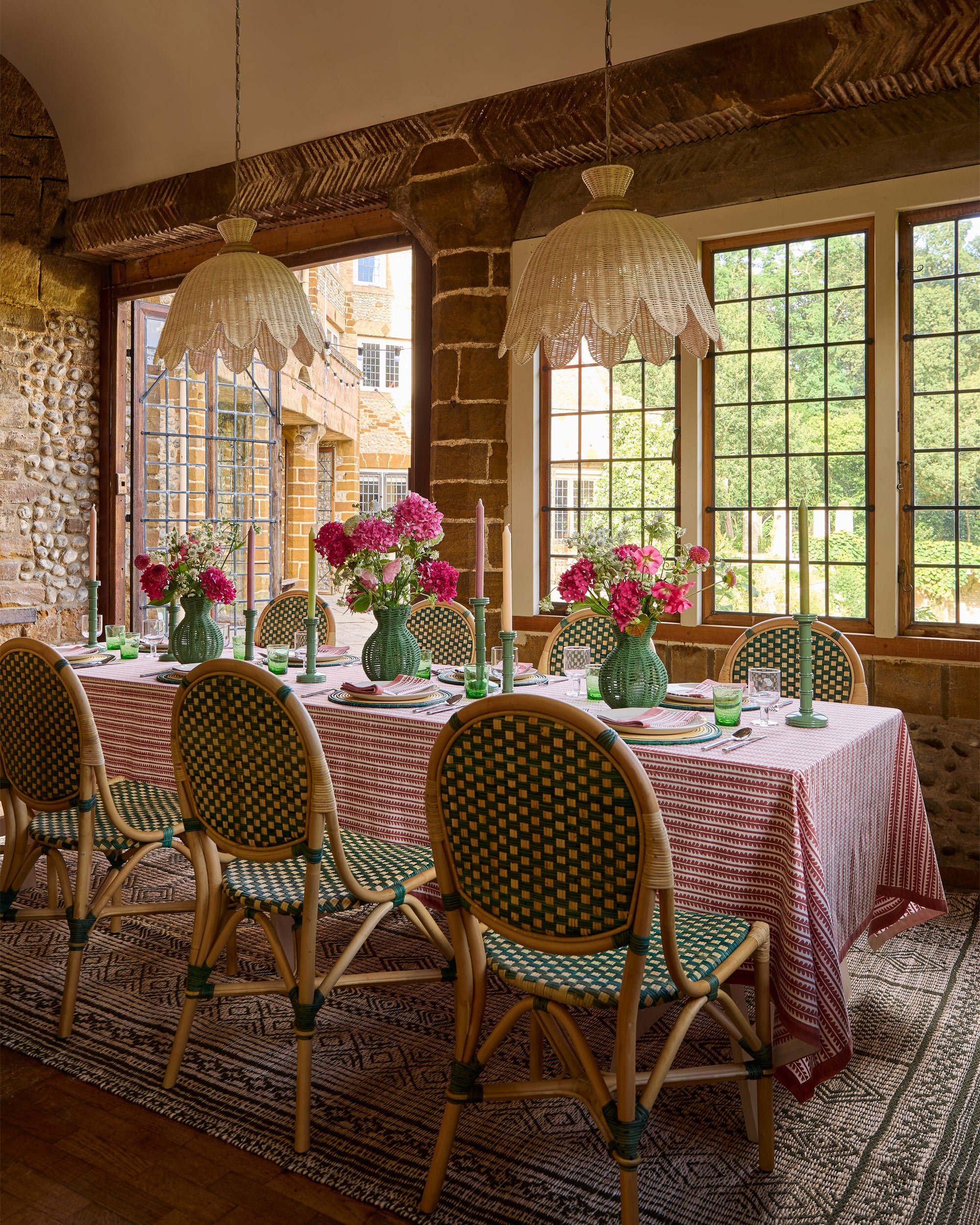 Pink and green summery dining tablescape, featuring pinks and greens and our natural rattan Campnilla pendant lights