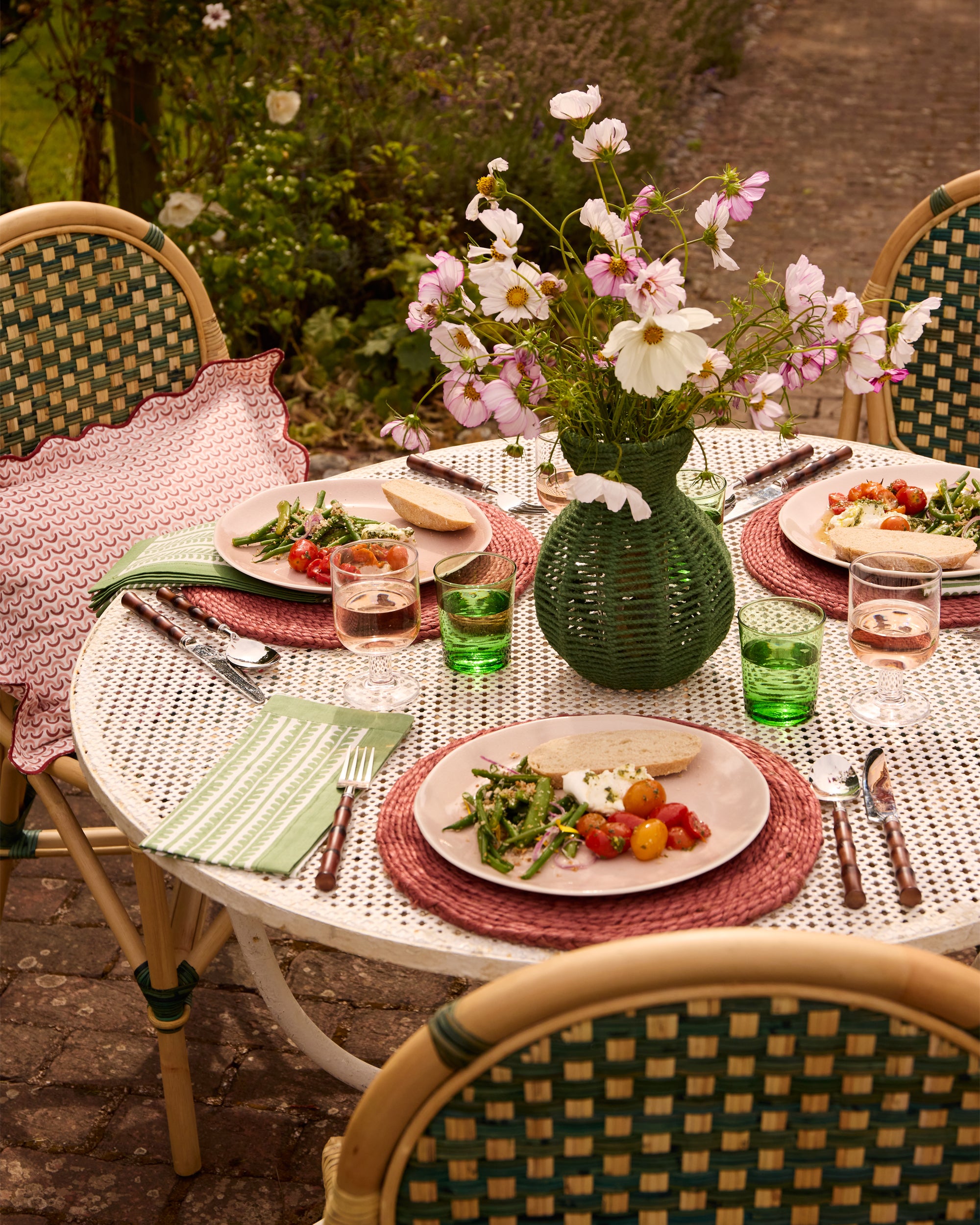 Spring summer outdoor dining lifestyle image, featuring our green string vase