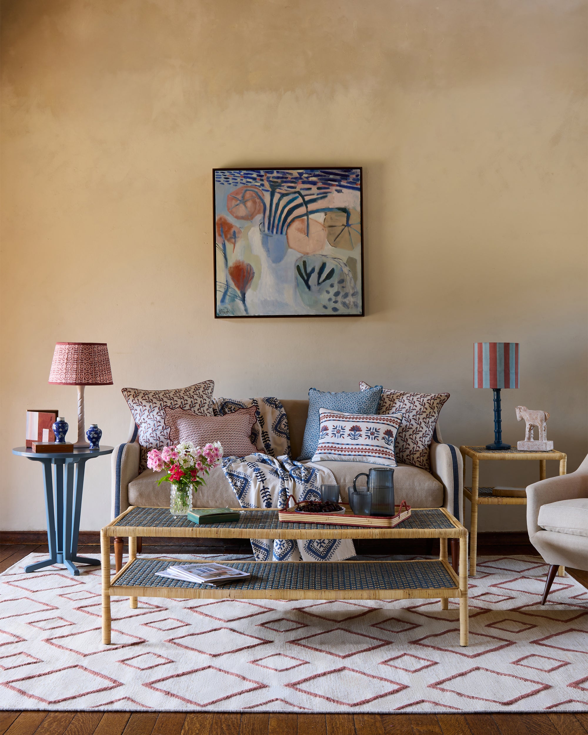 Pink and blue themed sitting room, styled with Birdie Fortescue's rattan and upholstered furniture and spring summer soft furnishings