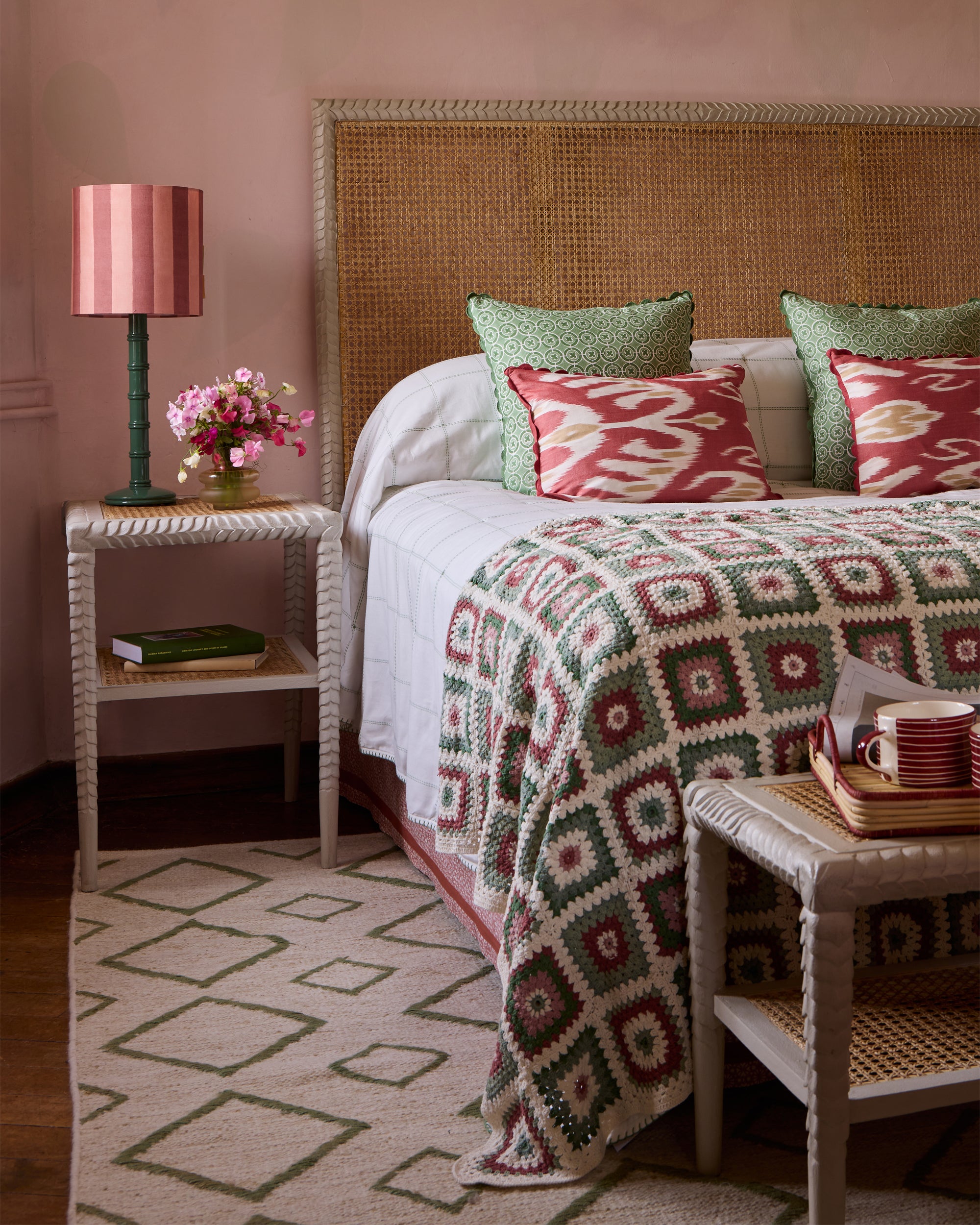 Pink and green themed bedroom, featuring the taupe pavilion furniture, green column lamp with the pink and red striped drum lampshade, pink and green crochet throw and green rhombus rug