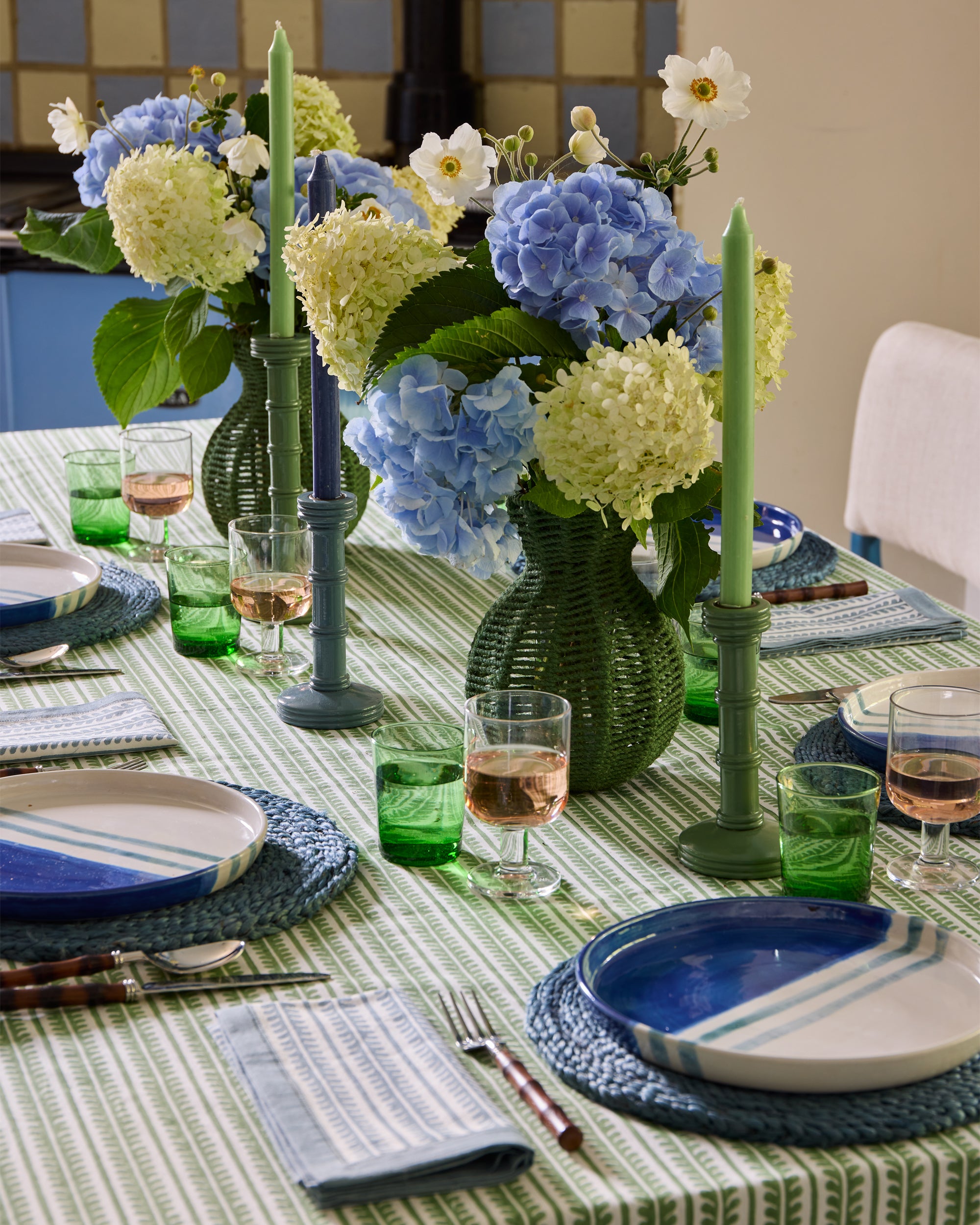 Blue and green tablescape, green string vases and column candlesticks as centre pieces