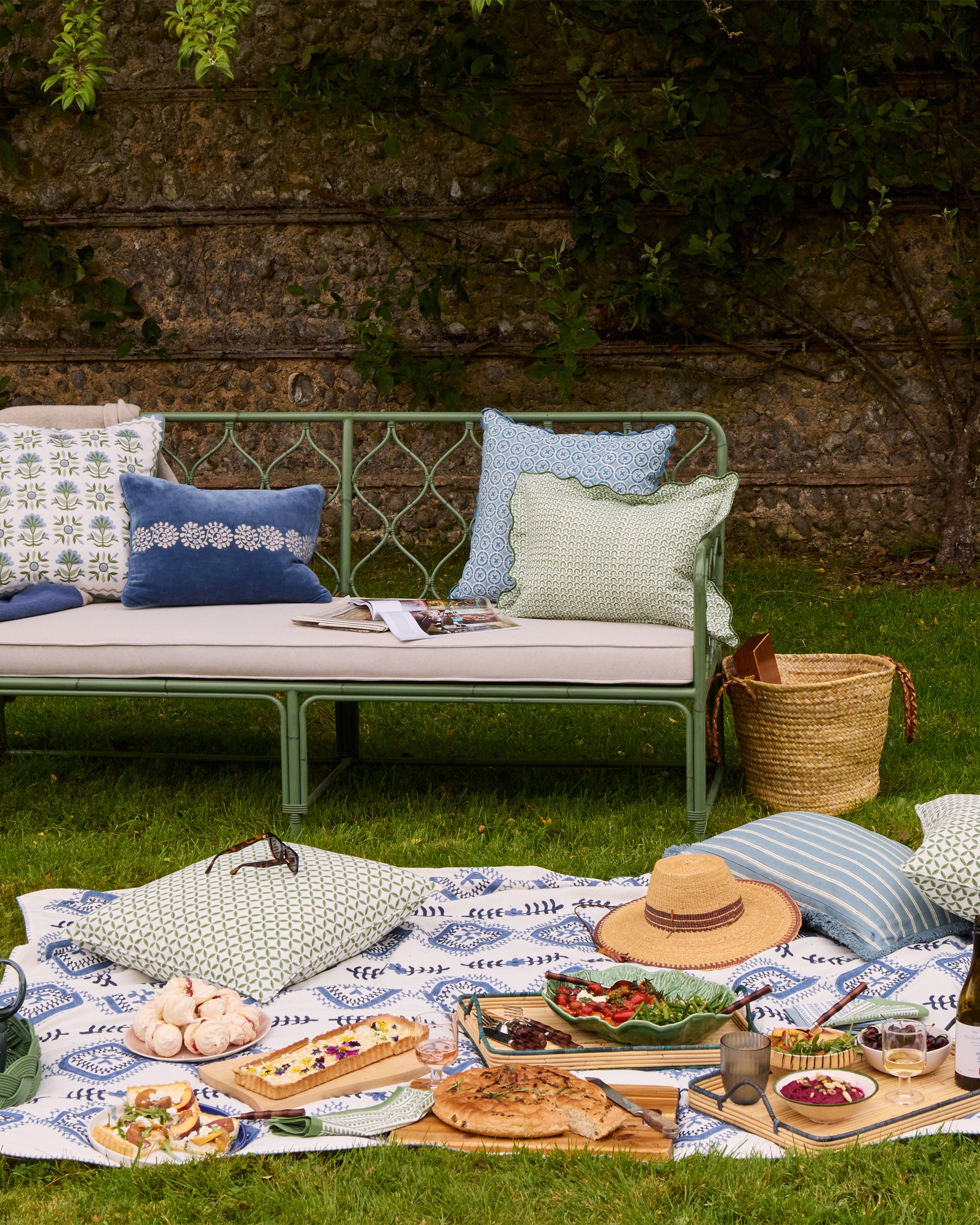 Outdoor spring summer picnic lifestyle image featuring Birdie Fortescue's soft furnishings and furniture