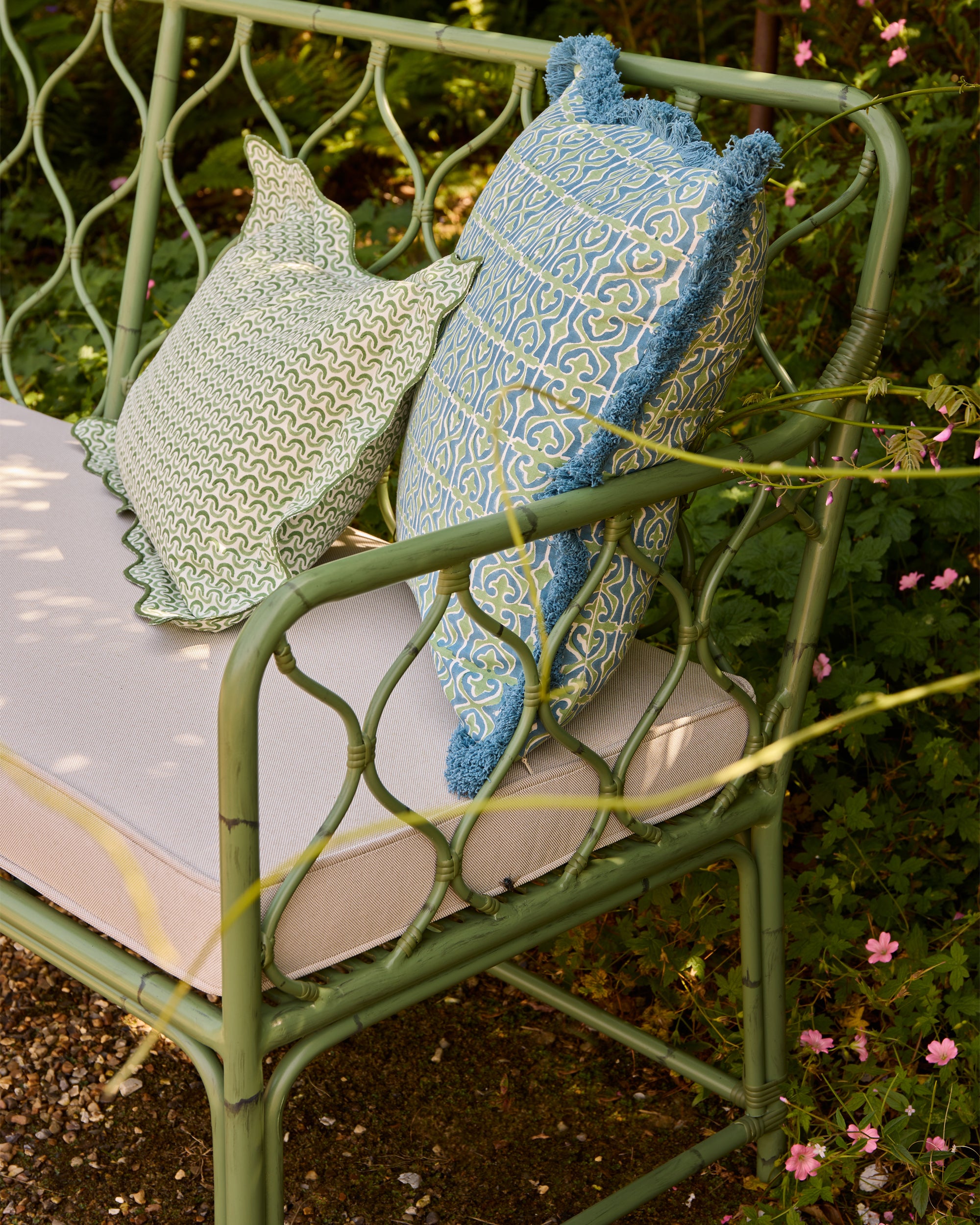 Spring summer outdoor curato sofa, styled with the green Teja scalloped block printed cushion and blue and green Santa Clara cushion