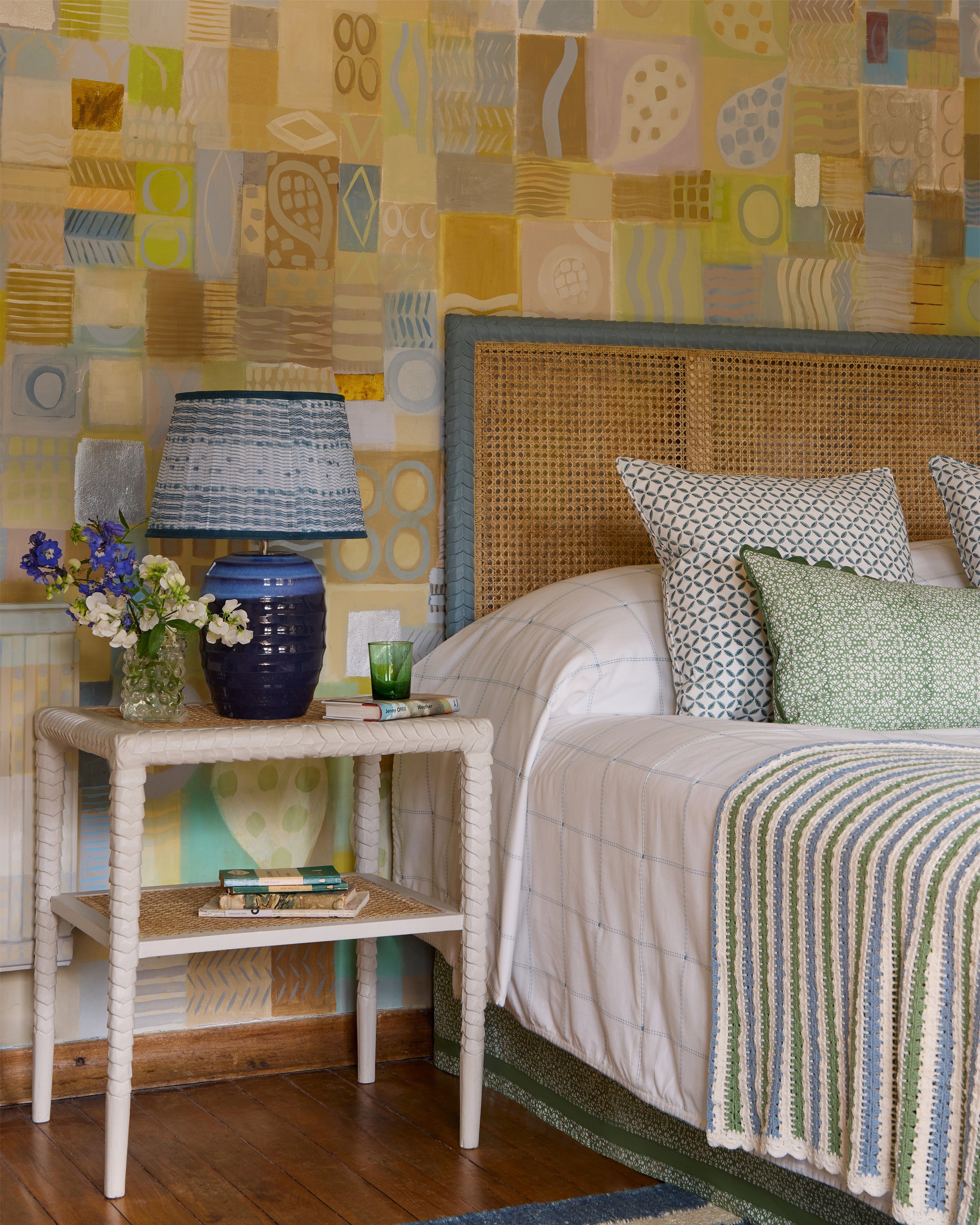 Close up blue and green bedroom lifestyle image, featuring the blue Beehive lamp with the blue Cantero pleated lampshade