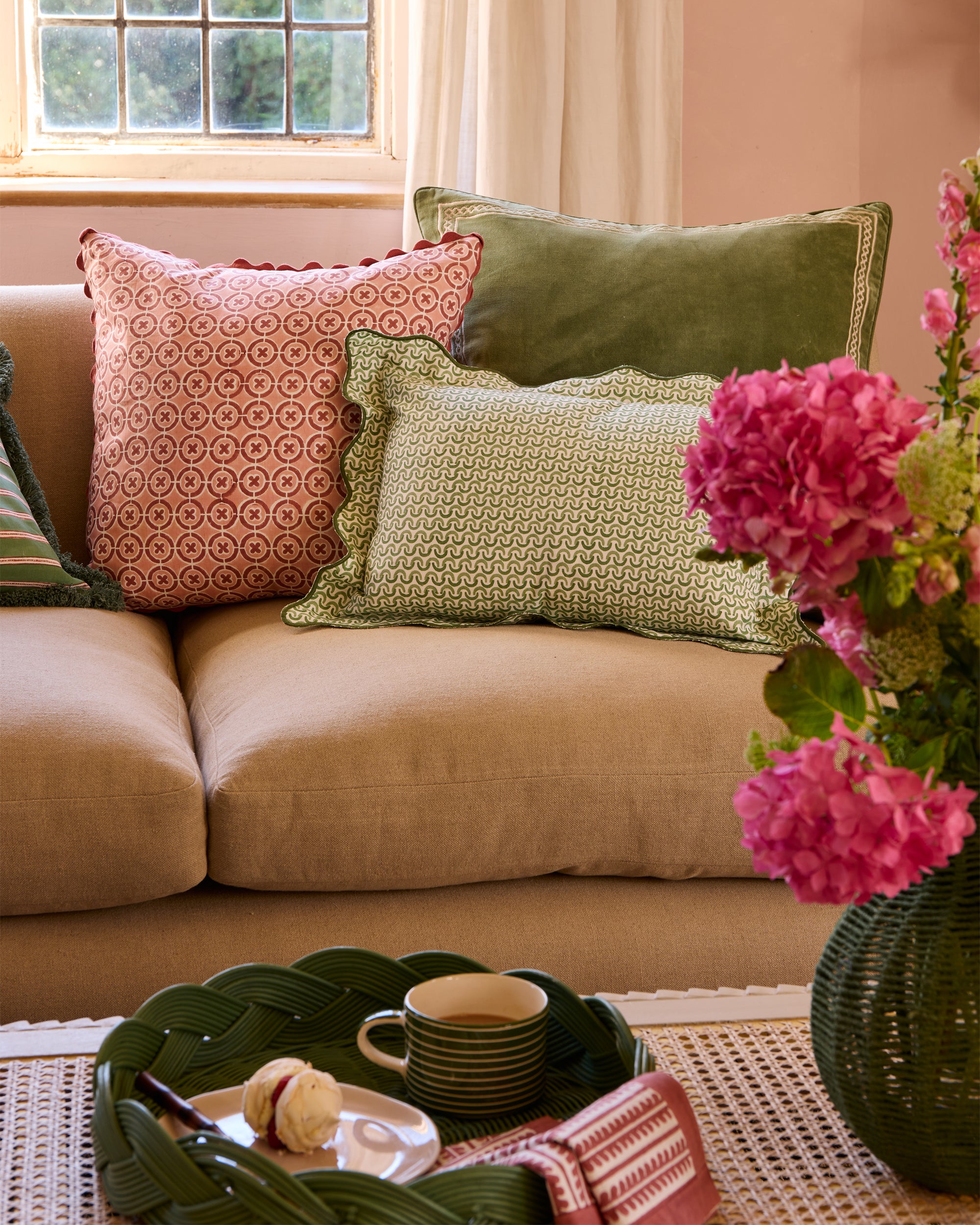 Pink and green sitting room, styled with the green Teja scalloped cushion, pink ciculo cushion and green shish cushion