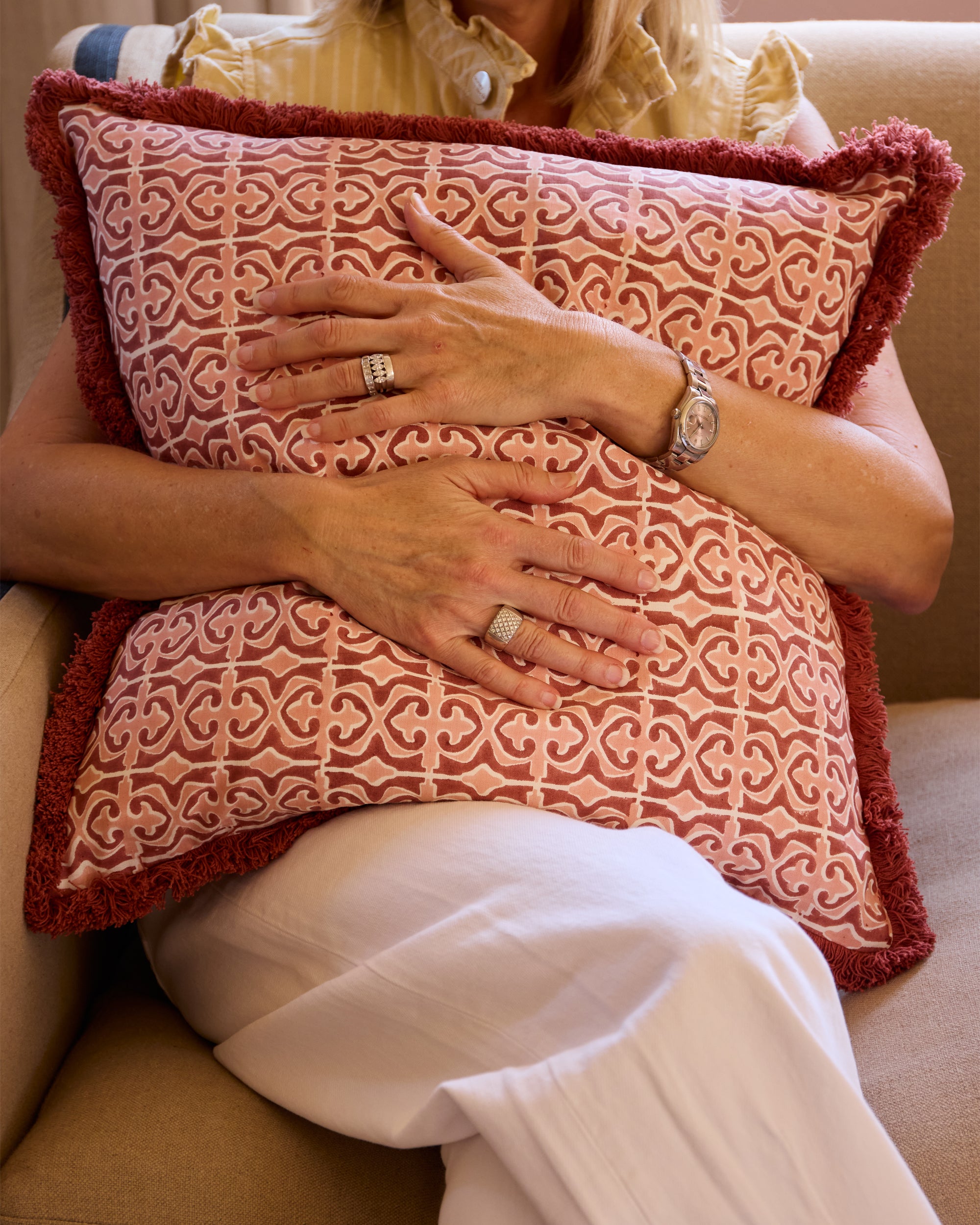 Close up detail image of the pink and red square Santa Clara block printed cushion