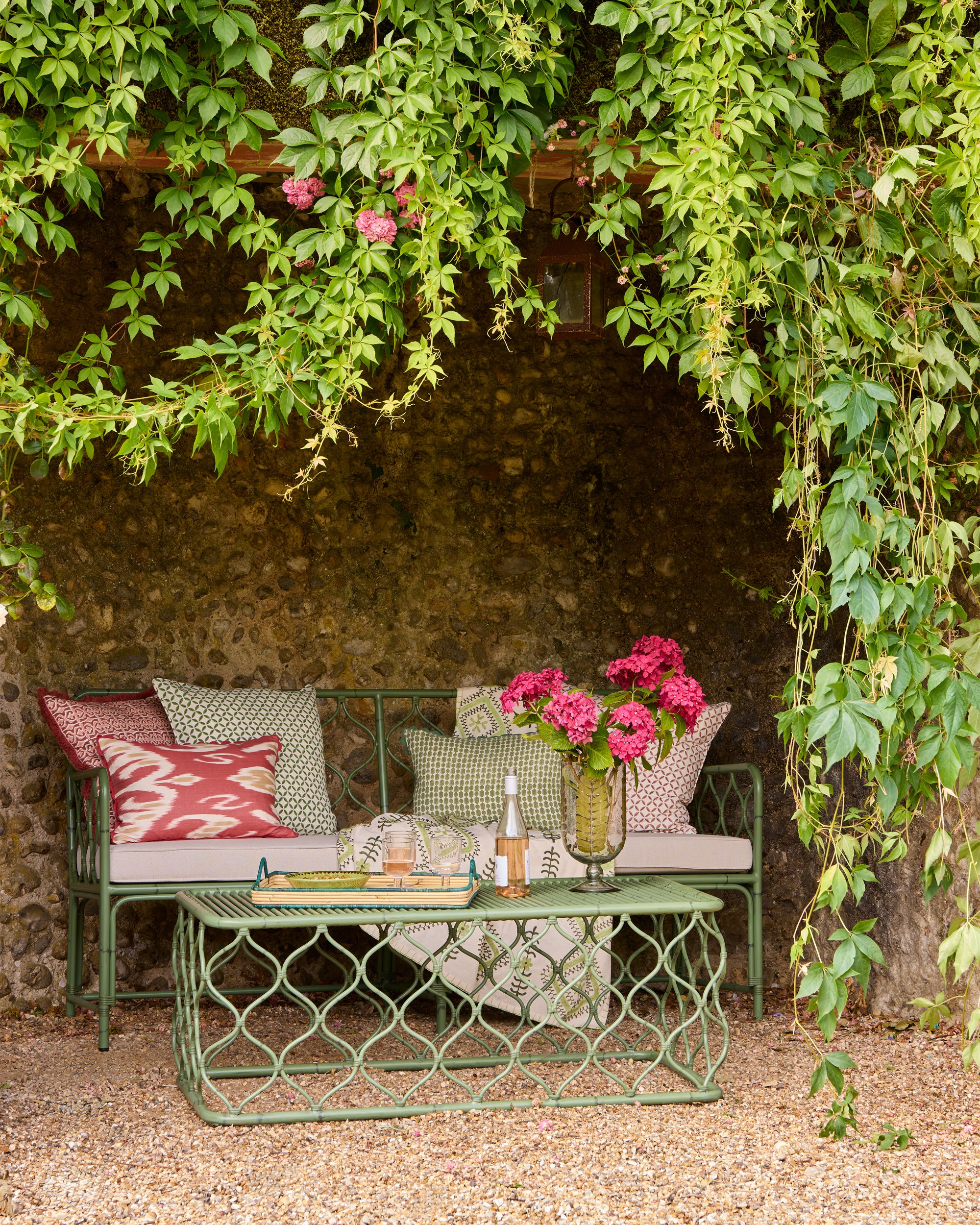 Spring summer outdoor seating lifestyle image - Birdie Fortescue soft furnishings and ss25 furniture