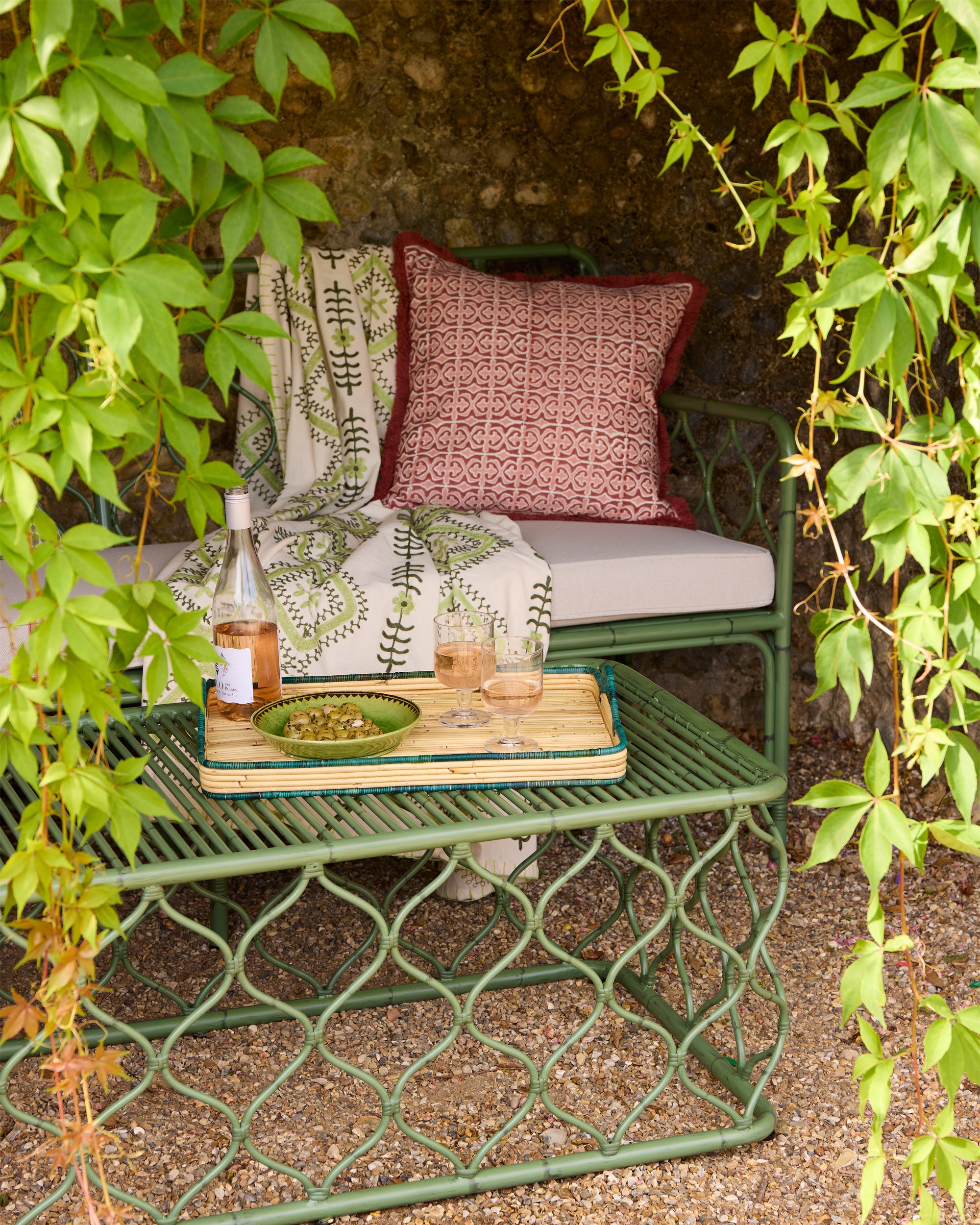 Summer outdoor garden cove lifestyle image, featuring the green Amrapali cuszani, Santa Clara Block Print Fringe Cushion, Curato Coffee Table and Curato Garden Sofa