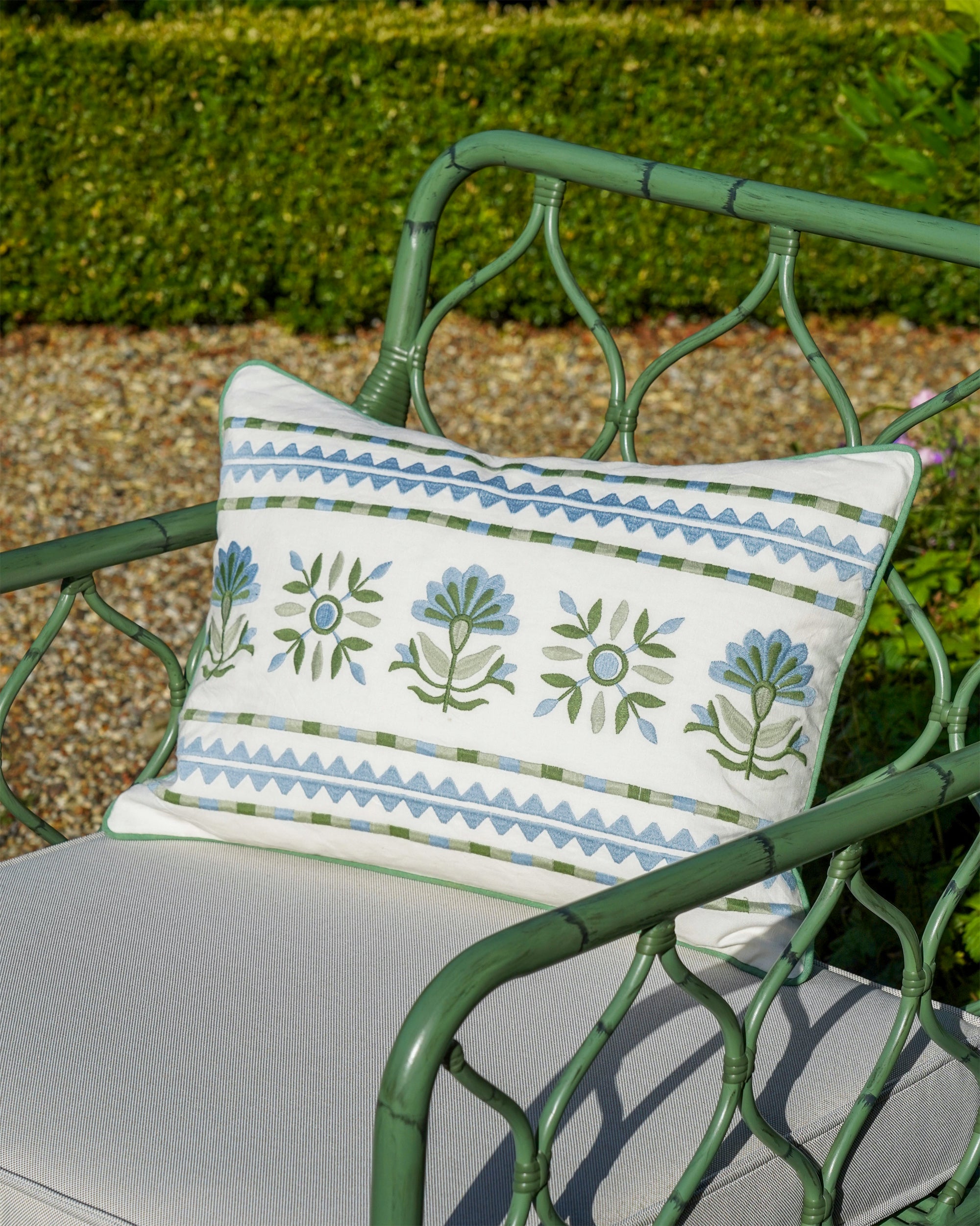 Blue and green Sancti rectangular cushion styled on the green curato armchair