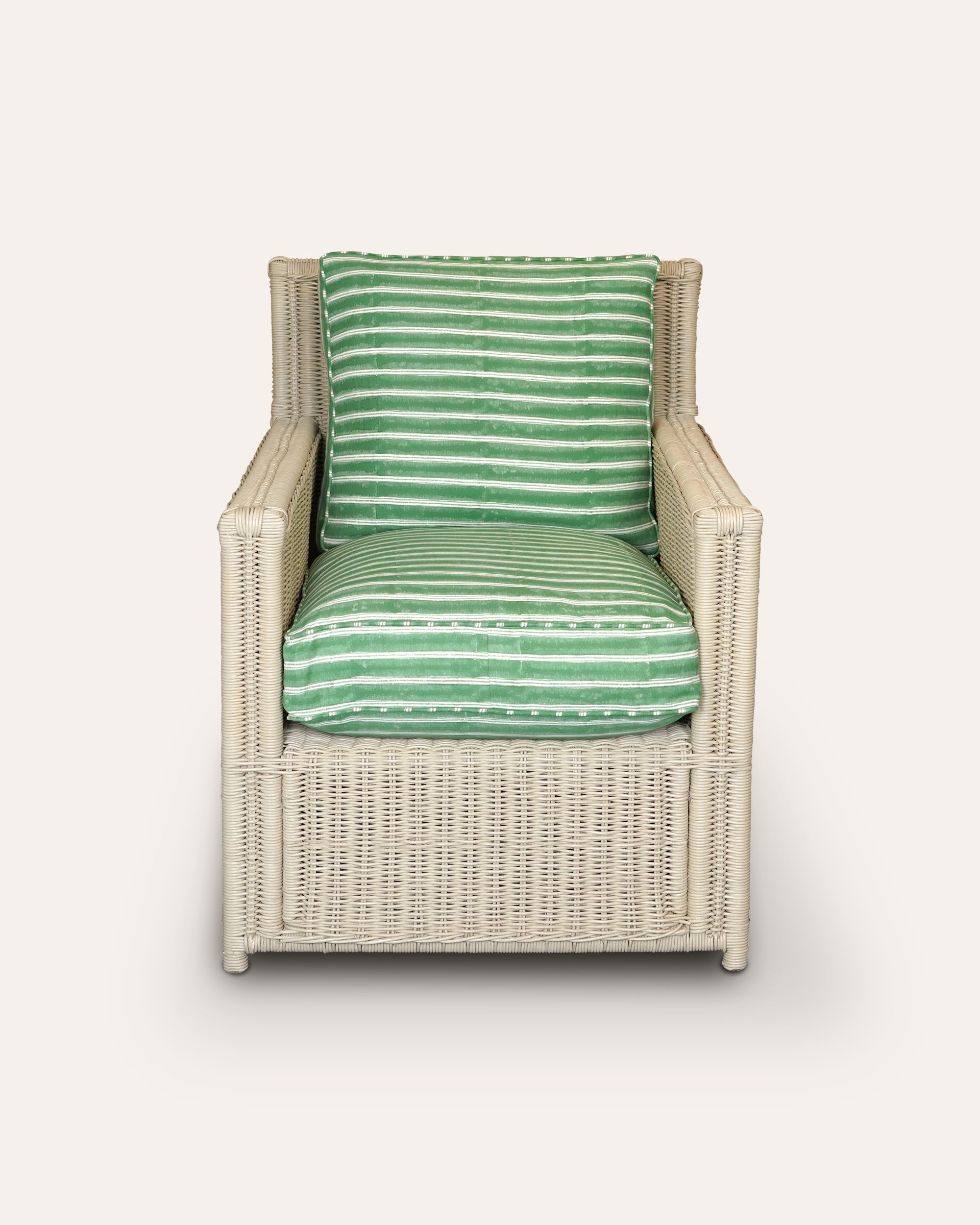 Wicker chair with green striped cushions on a white background