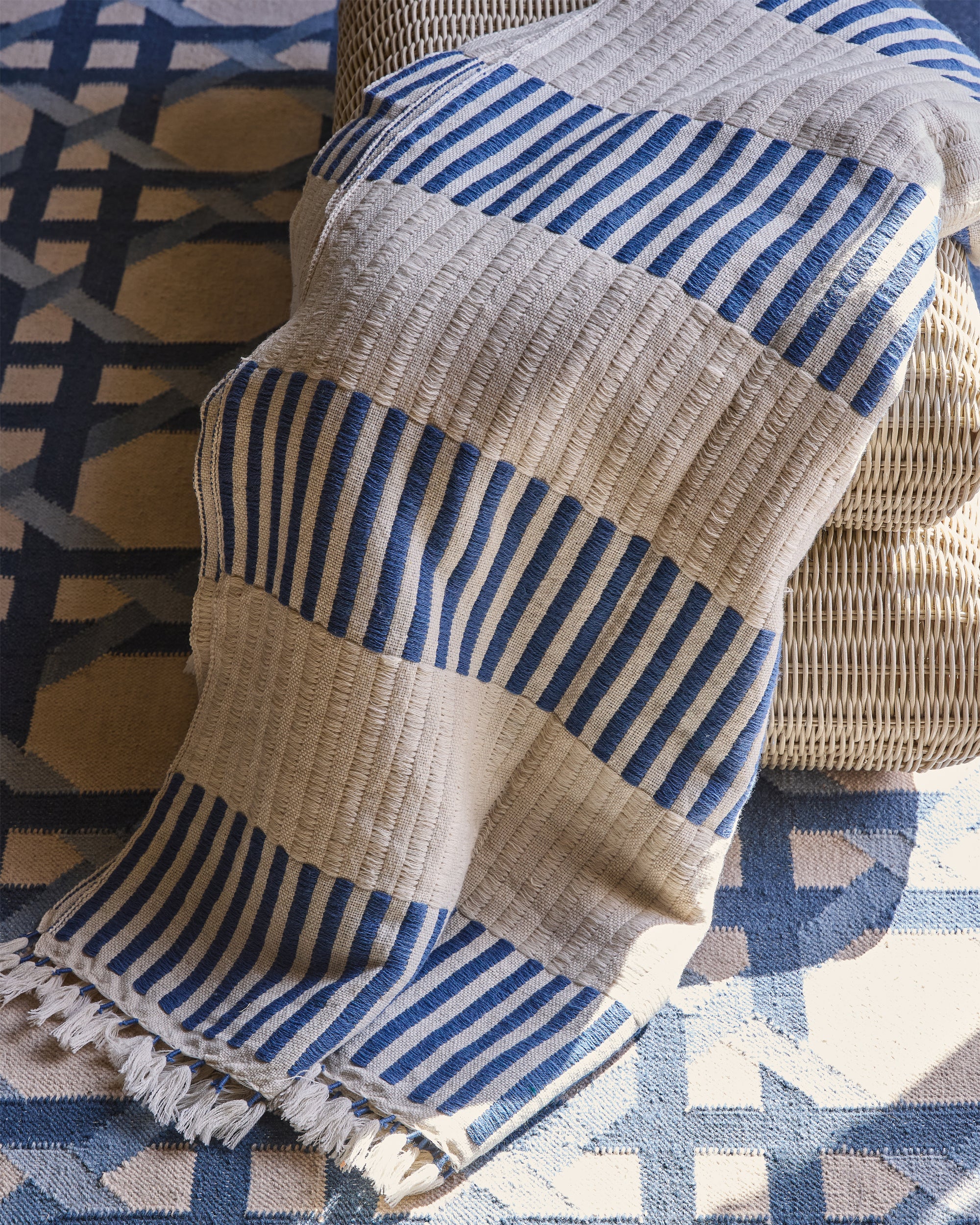 Blue and beige striped fabric draped over a textured surface