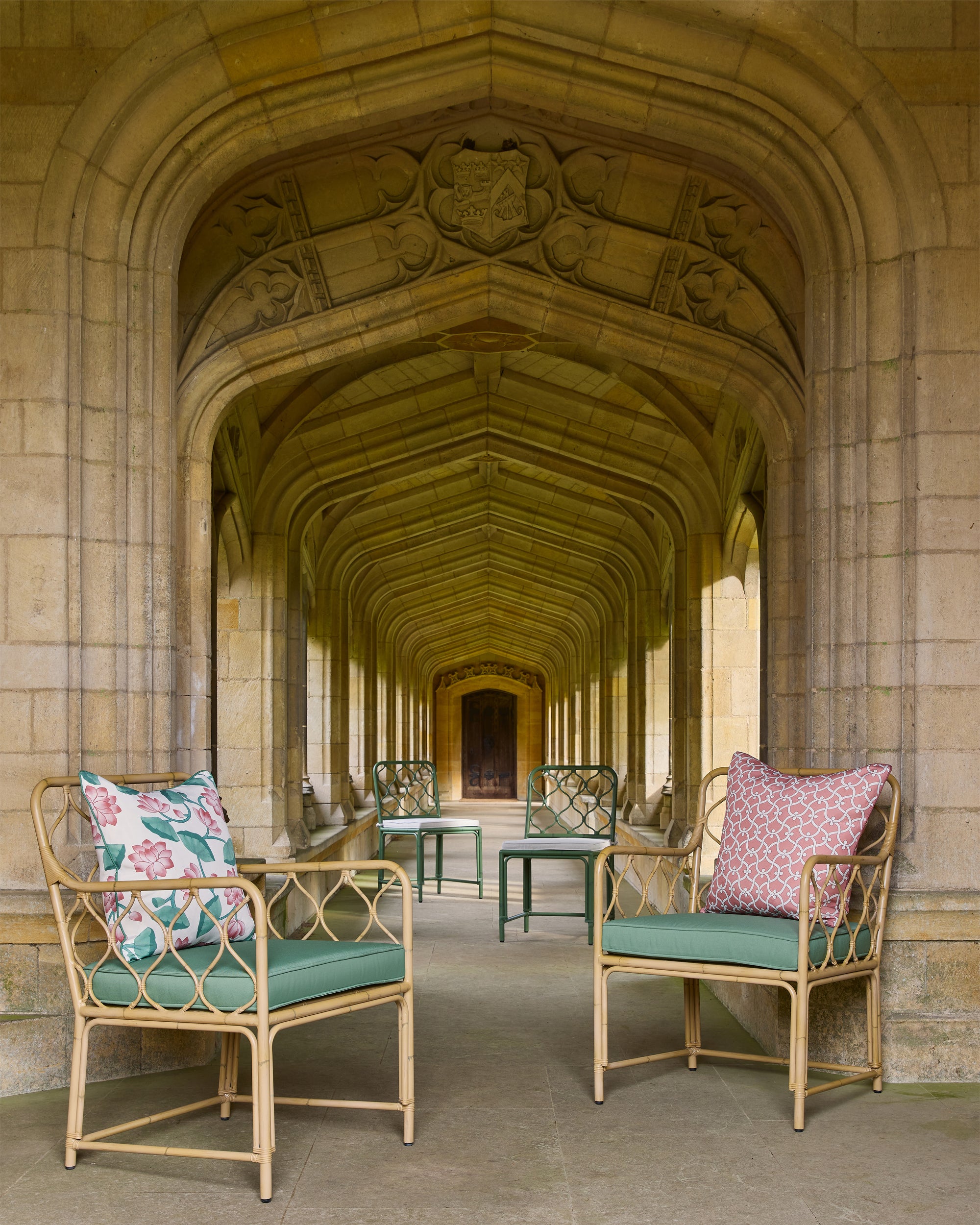 Decorative chairs with cushions in a stone archway corridor
