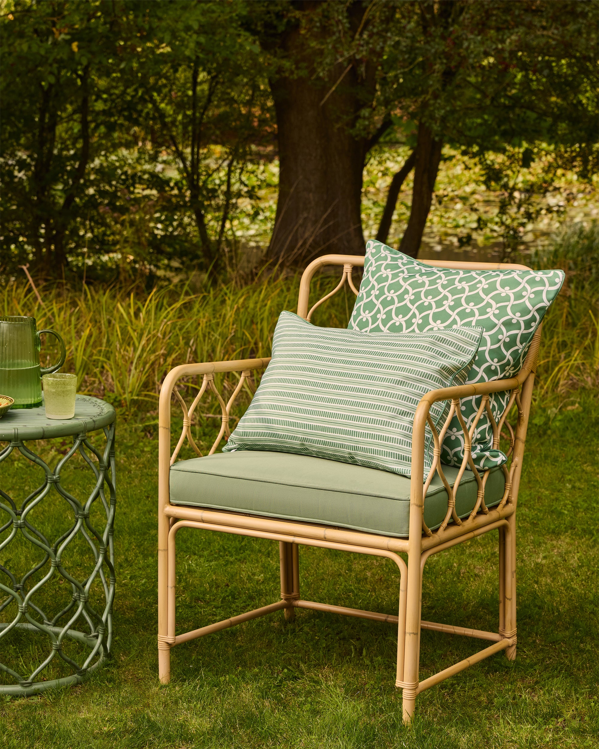Rattan chair with cushions in a garden setting