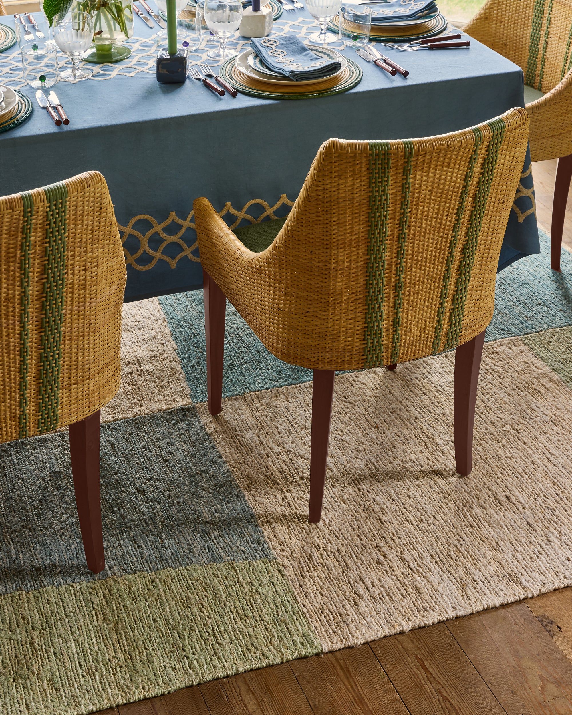 Dining table set with chairs on an abstract rug