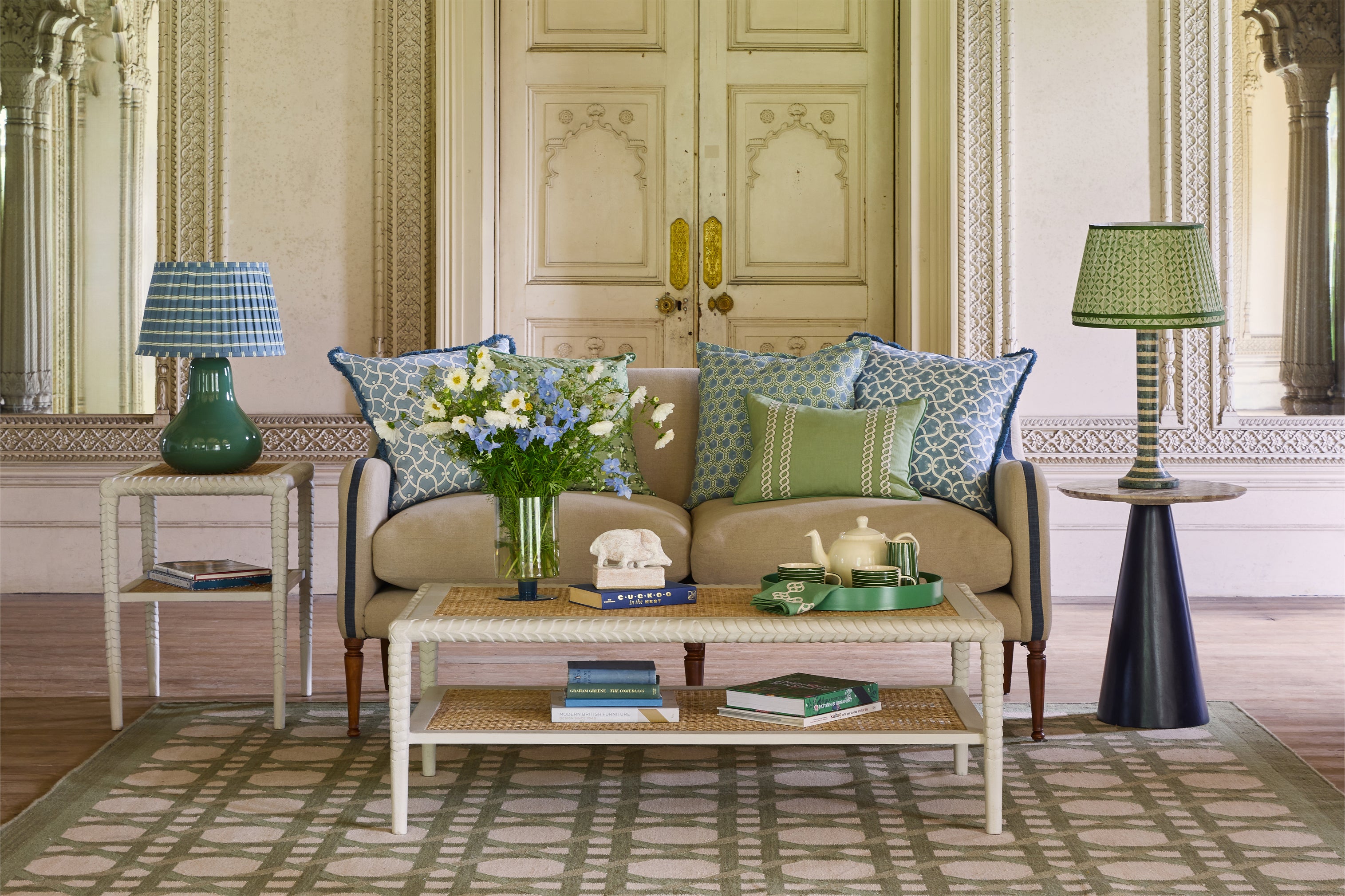 Living room with a beige sofa, coffee table, and decorative items.