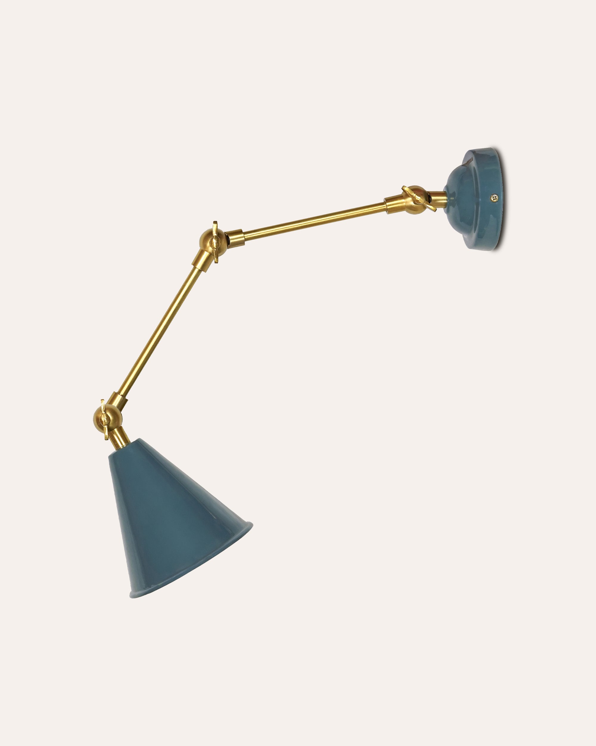 Wall-mounted lamp with blue shades and gold arm on a white background