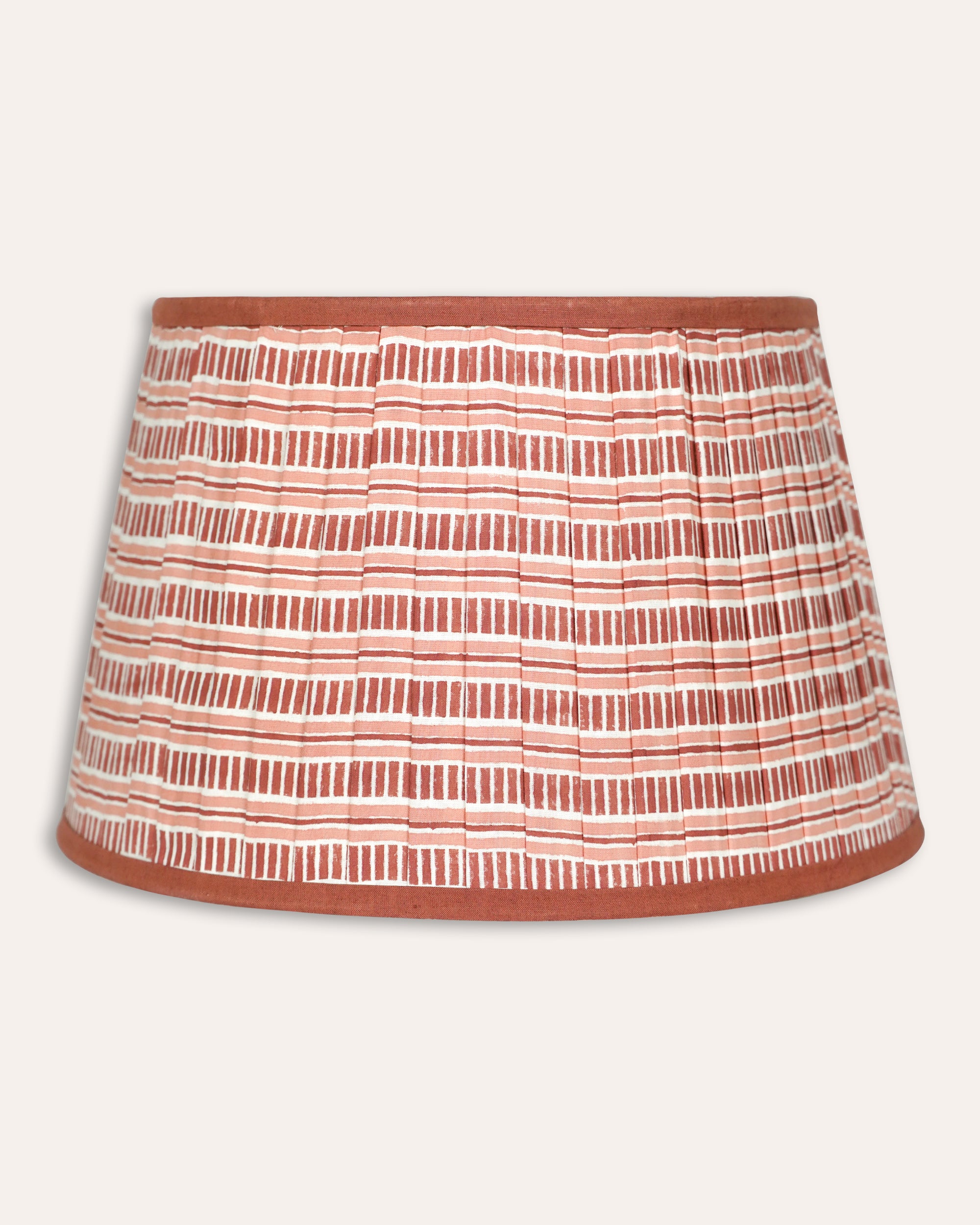 Striped lampshade with a pattern of red and white lines on a light grey background