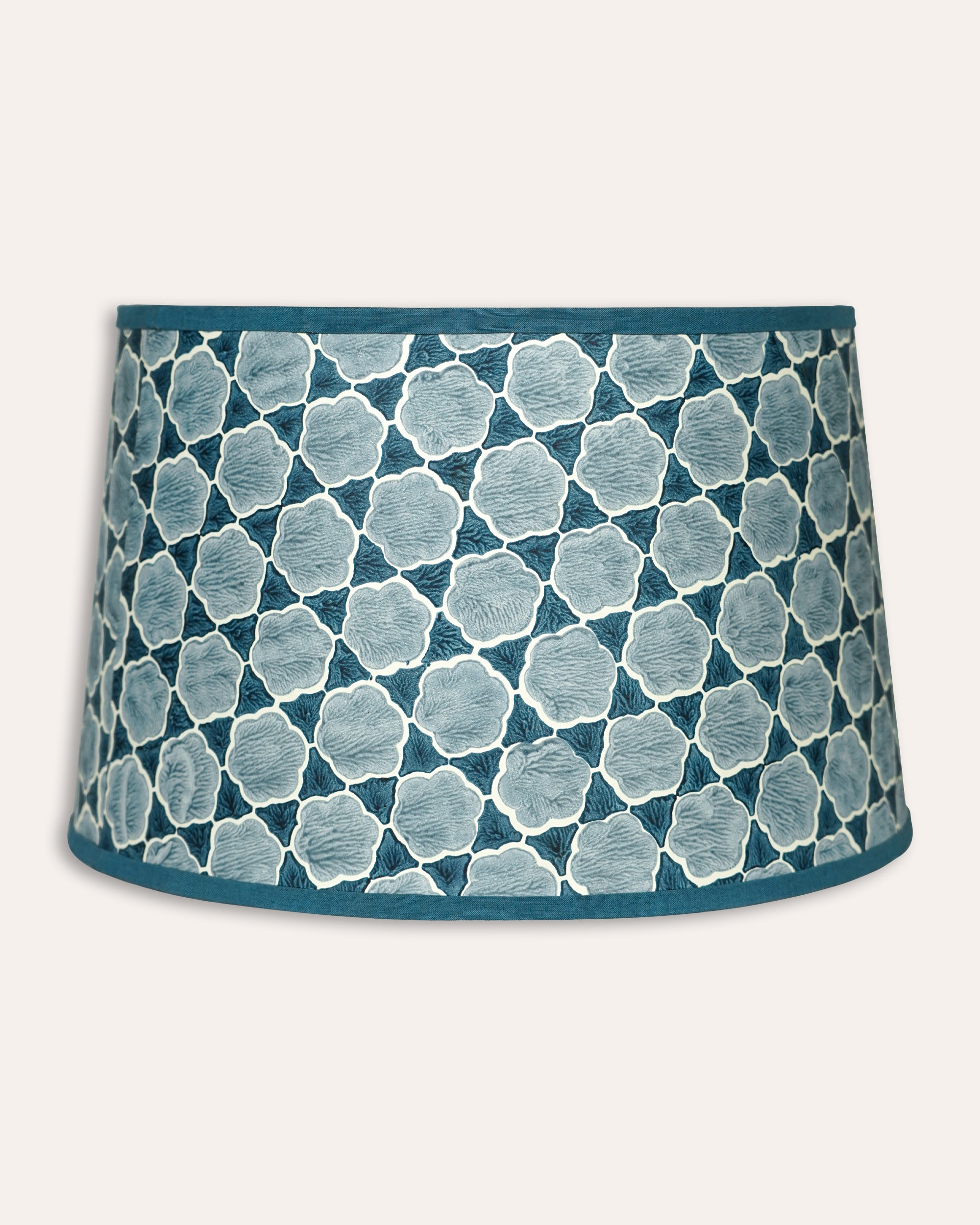 Blue and white patterned lampshade on a white background
