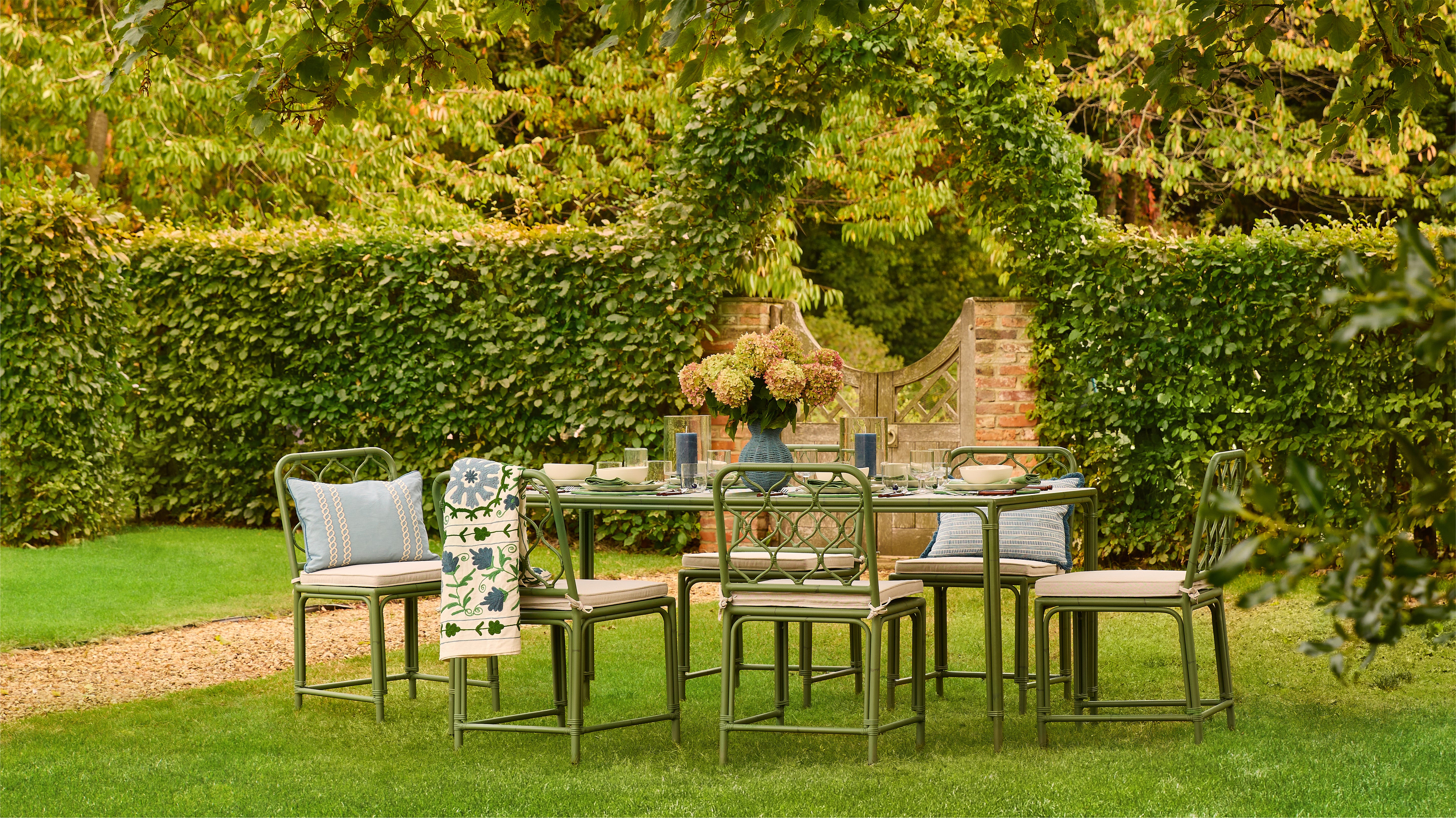 Outdoor dining set with table and chairs in a garden setting