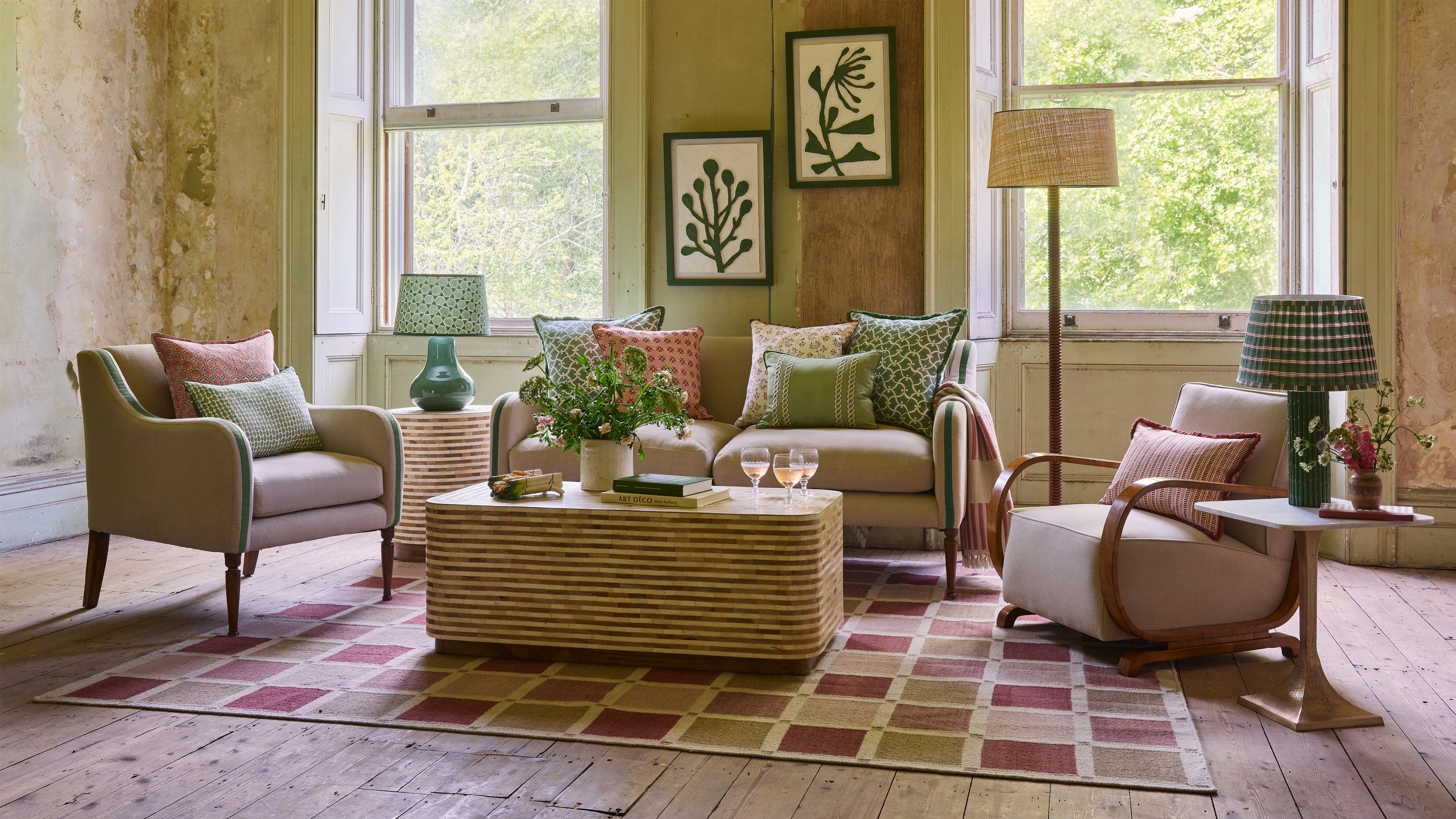 Living room with beige armchairs, a coffee table, and decorative elements.