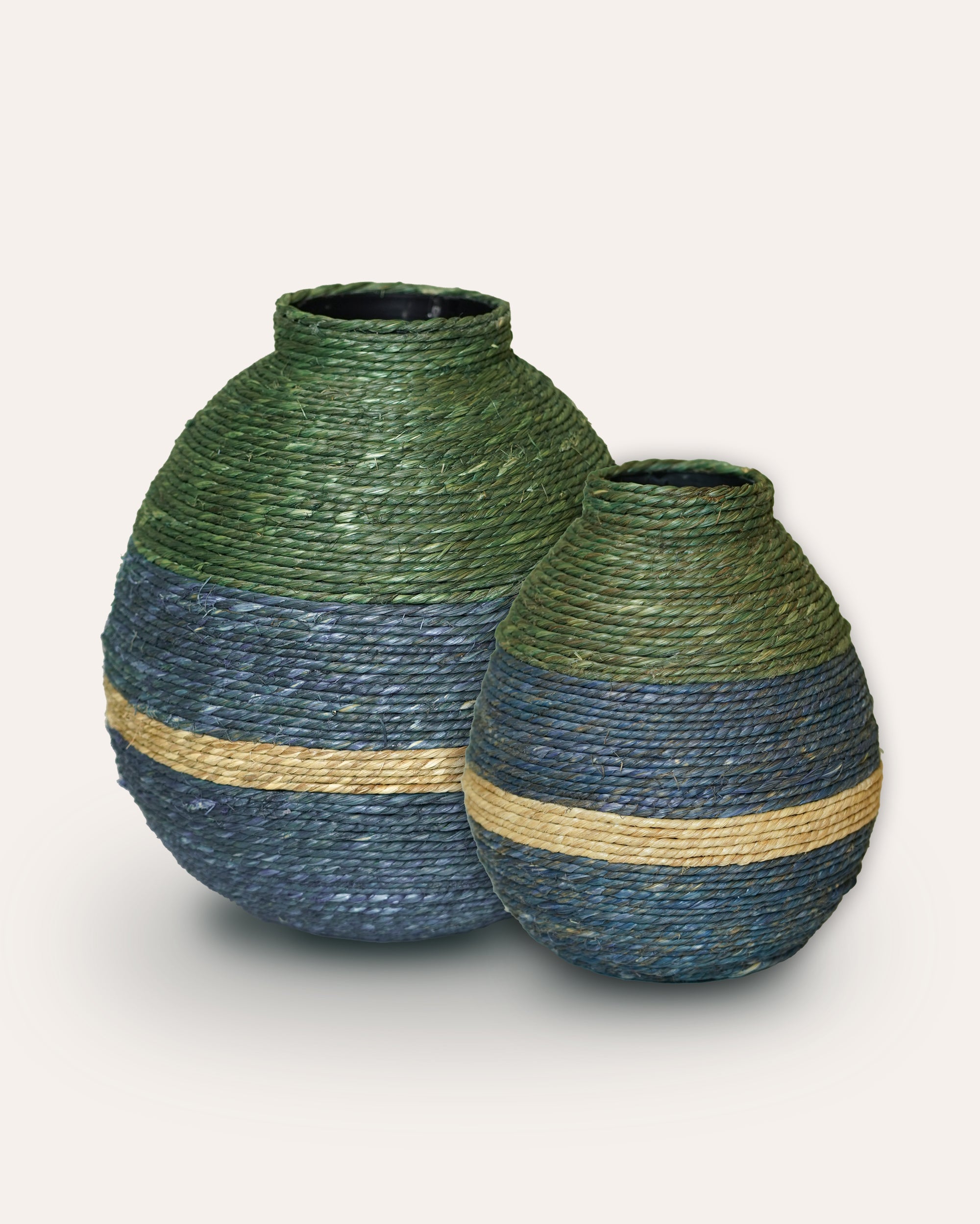 Two woven vases with green and blue striped design on a white background