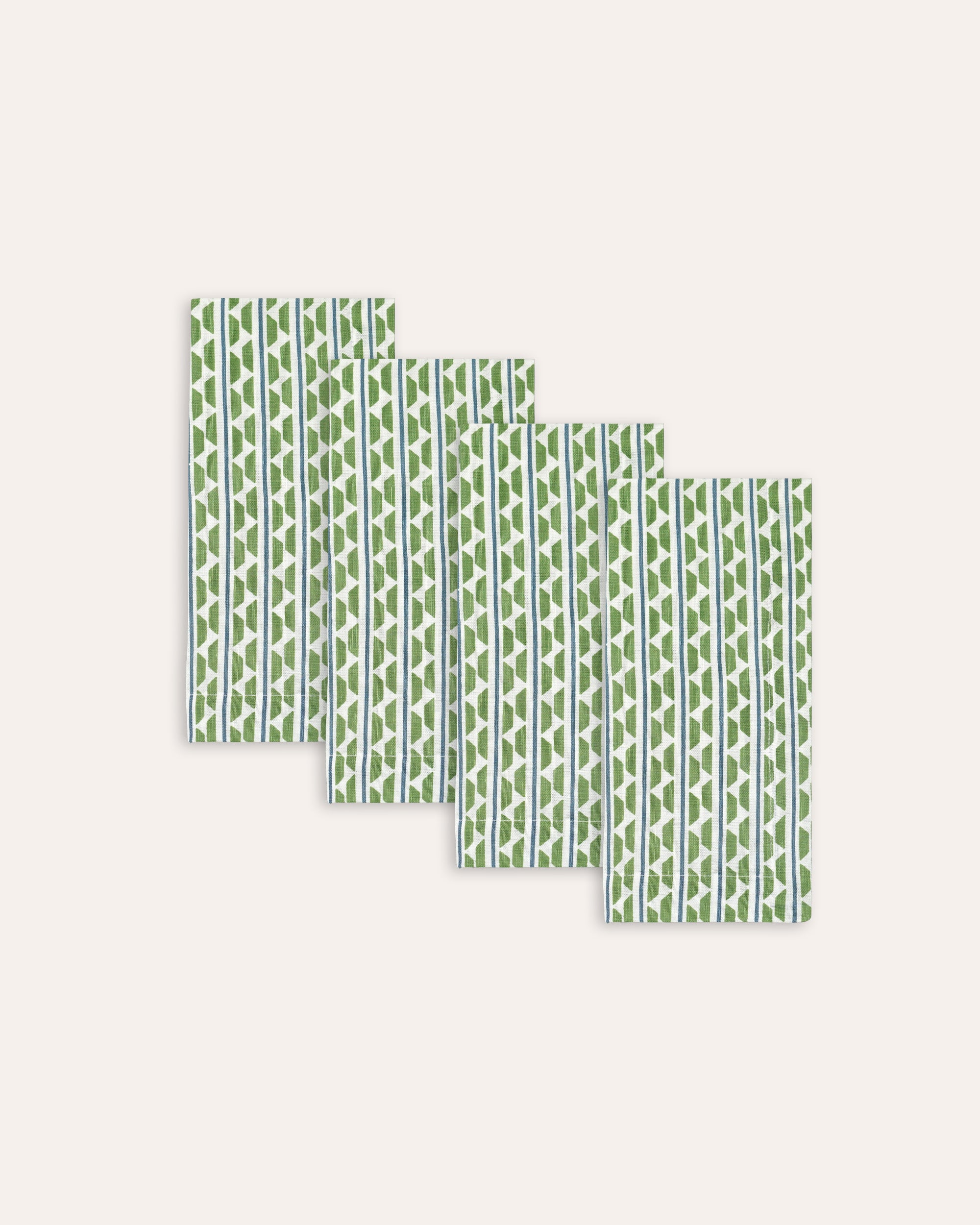 Set of green patterned napkins on a white background