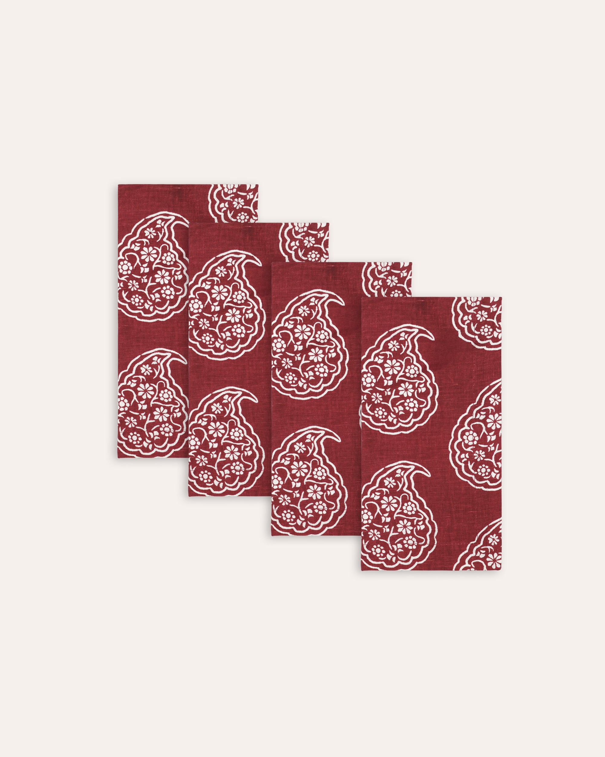 Set of four red patterned napkins on a white background
