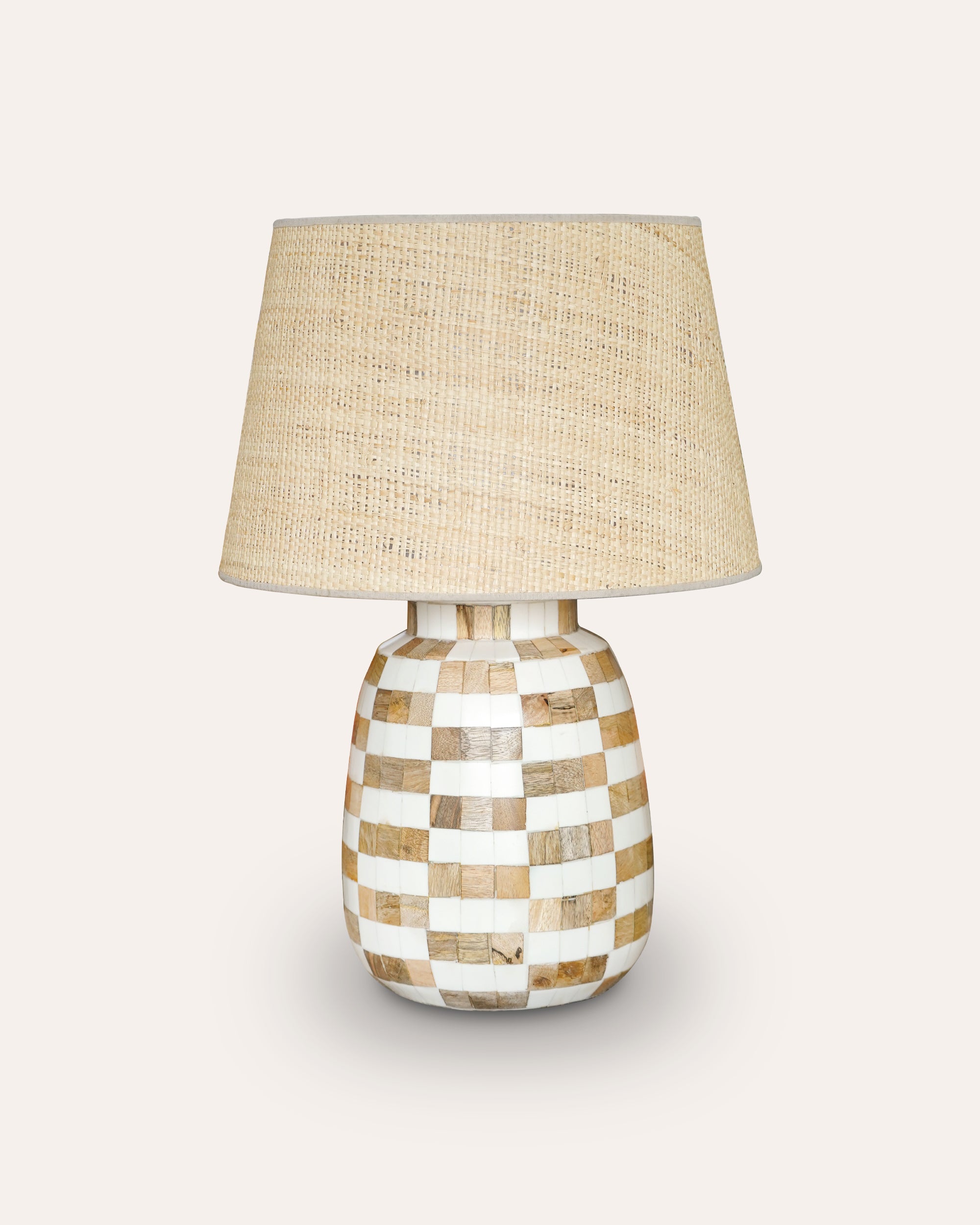Table lamp with checkered design and natural shade on a light background