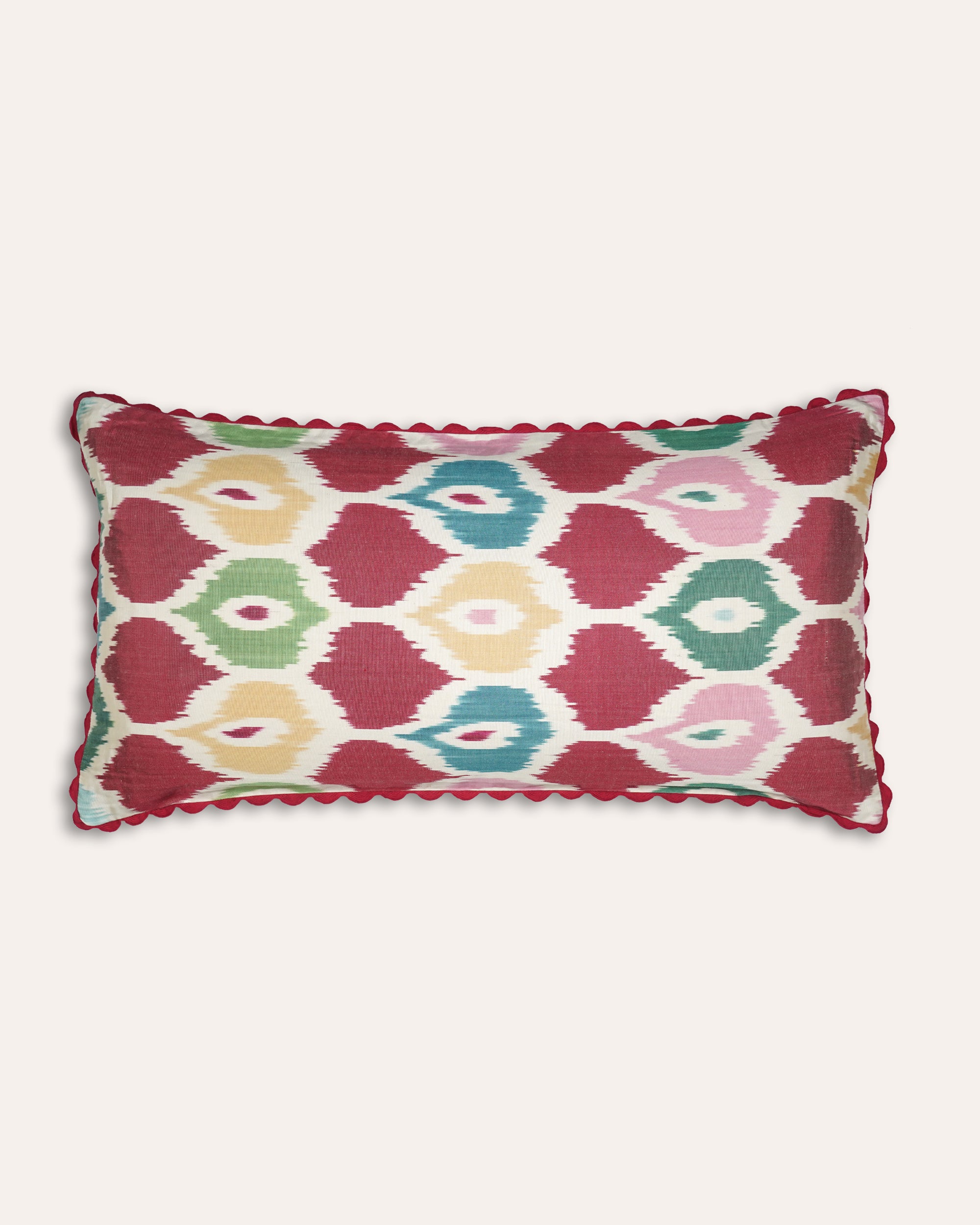Decorative rectangular cushion with a colourful geometric pattern on a white background
