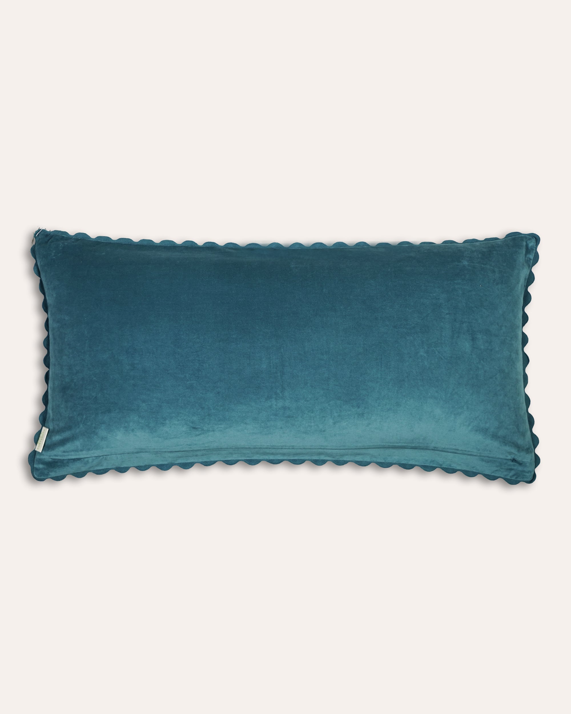 Large blue velvet cushion back with scalloped edge on a white background